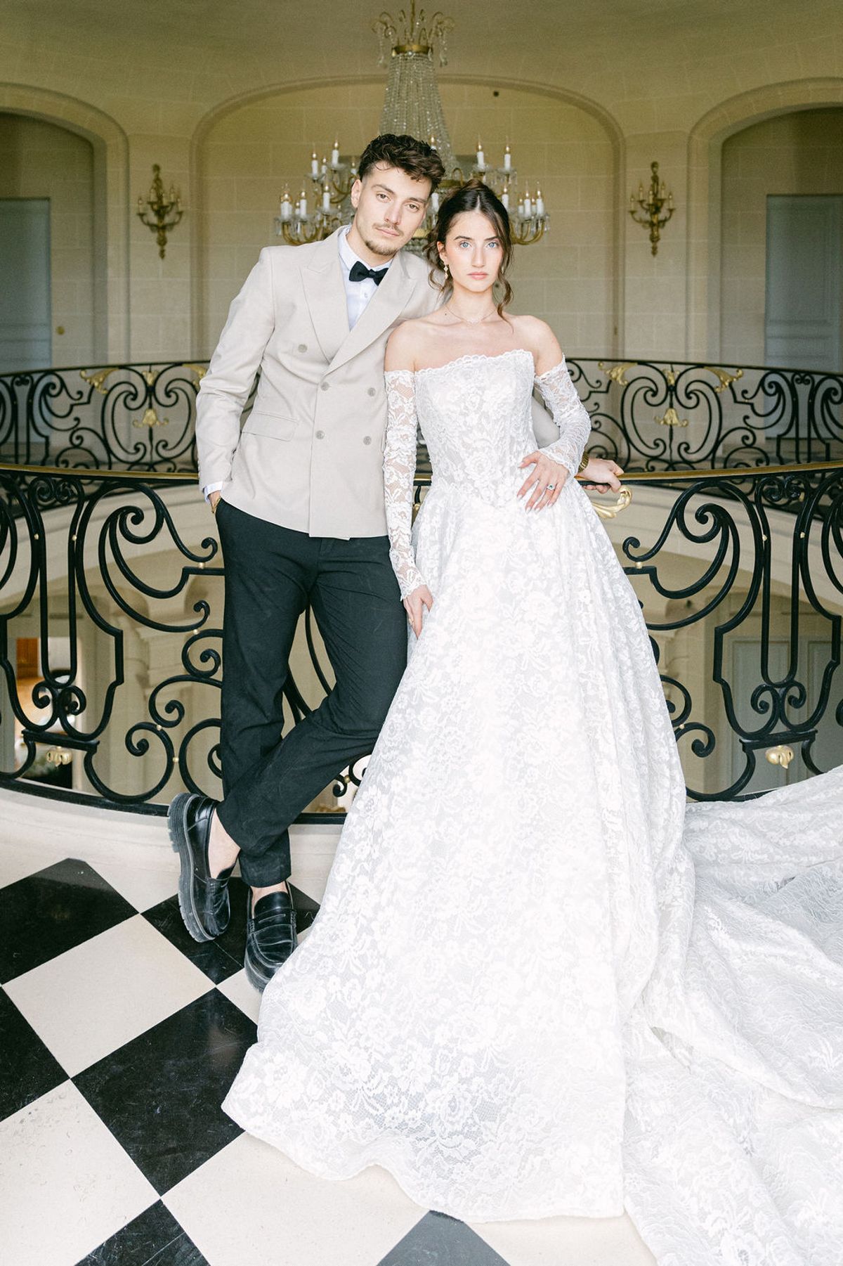 Couple on the black and white chequerboard floor of the chateau entrance hall