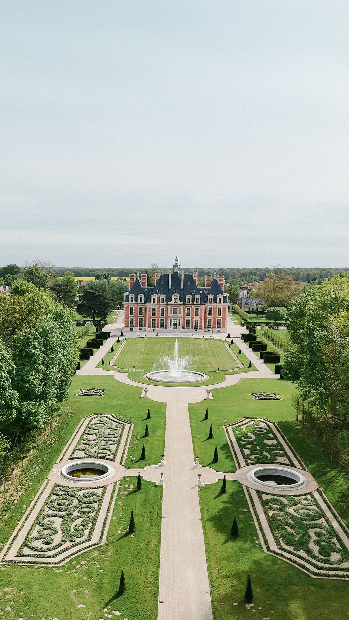Aerial view of the chateau's formal gardens and central fountain