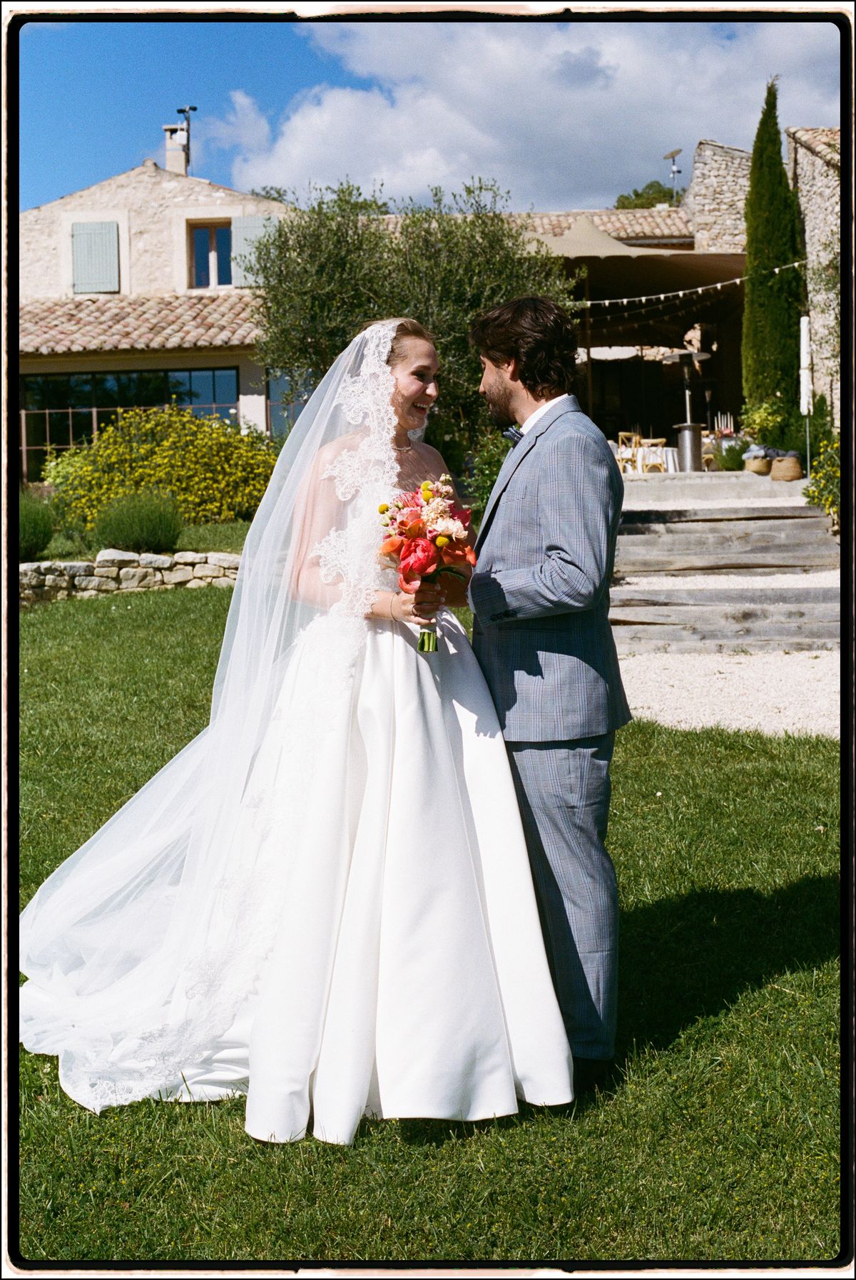 Bride and groom facing each other, bride holding her bouquet