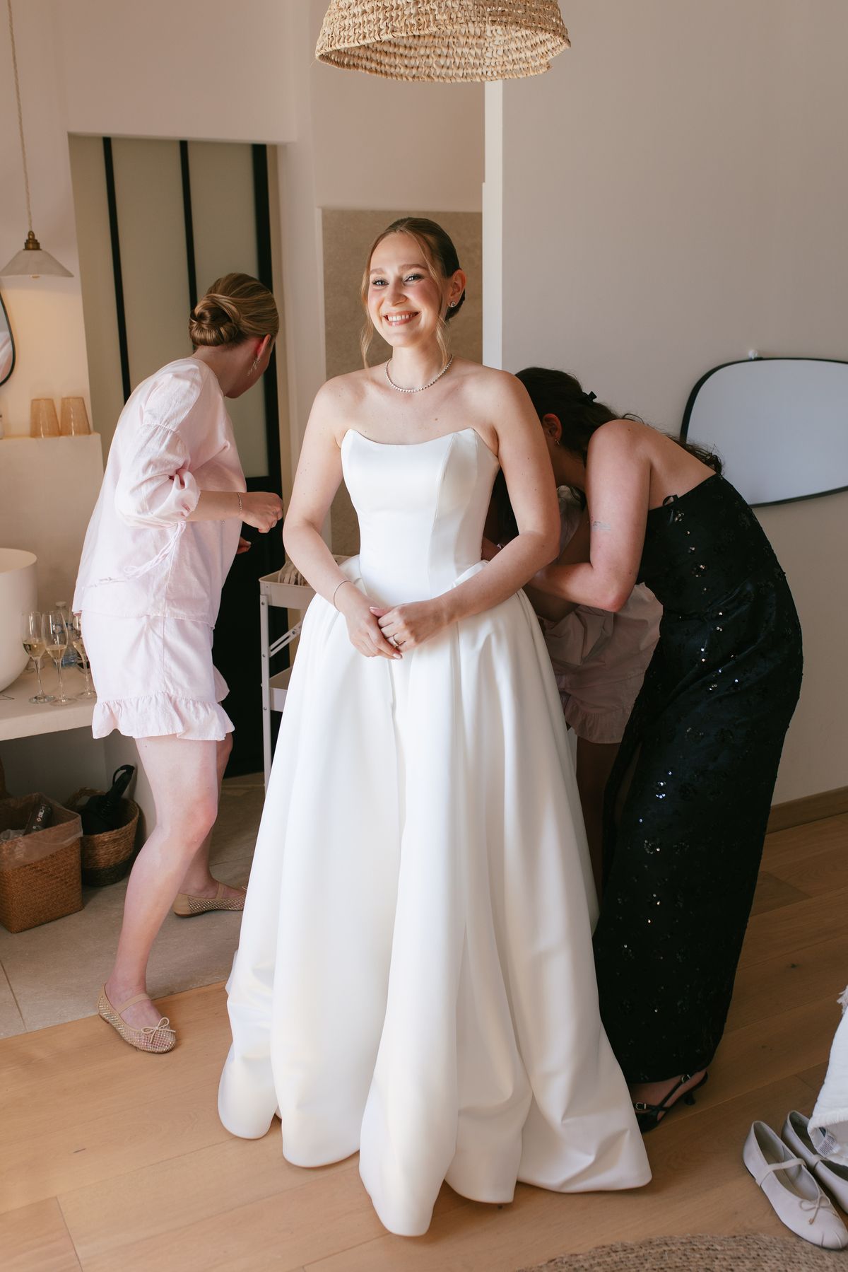 Bride being helped into her wedding gown