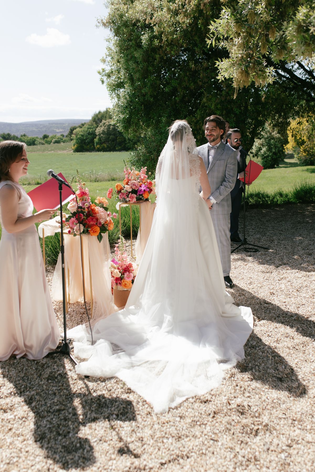 Officiant speaking during the ceremony as the bride listens