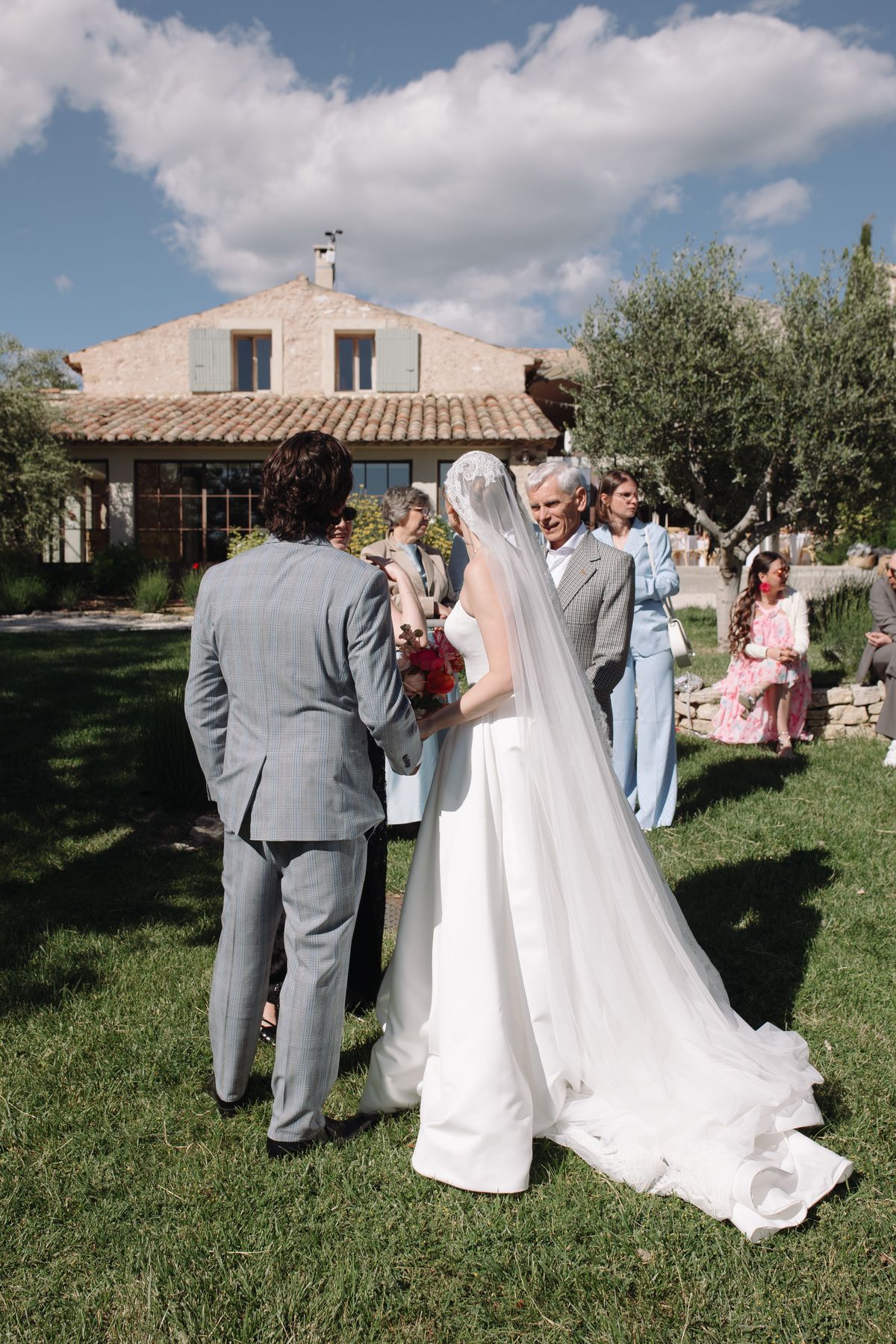Guests gathered around the bride and groom outside Mas de Florette