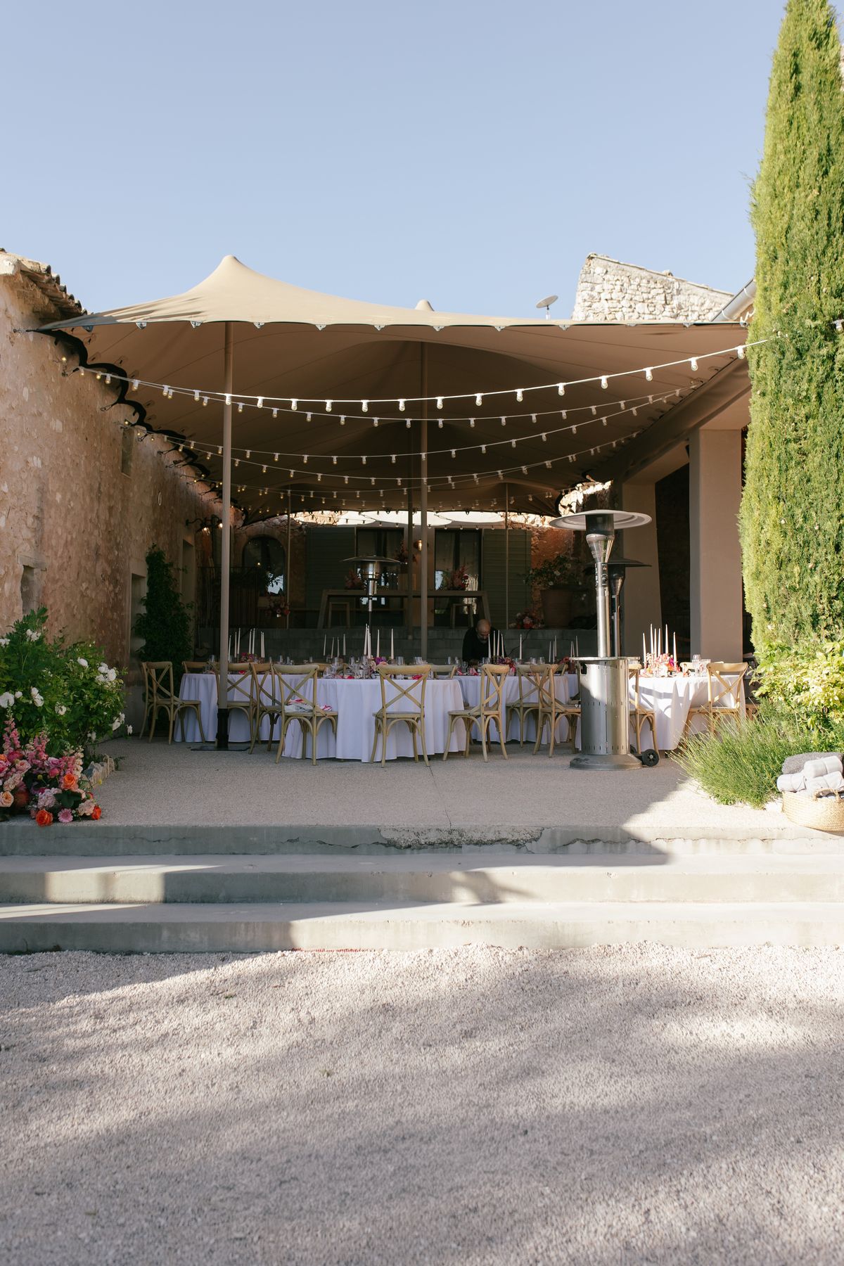 Reception dinner space set under string lights at Mas de Florette