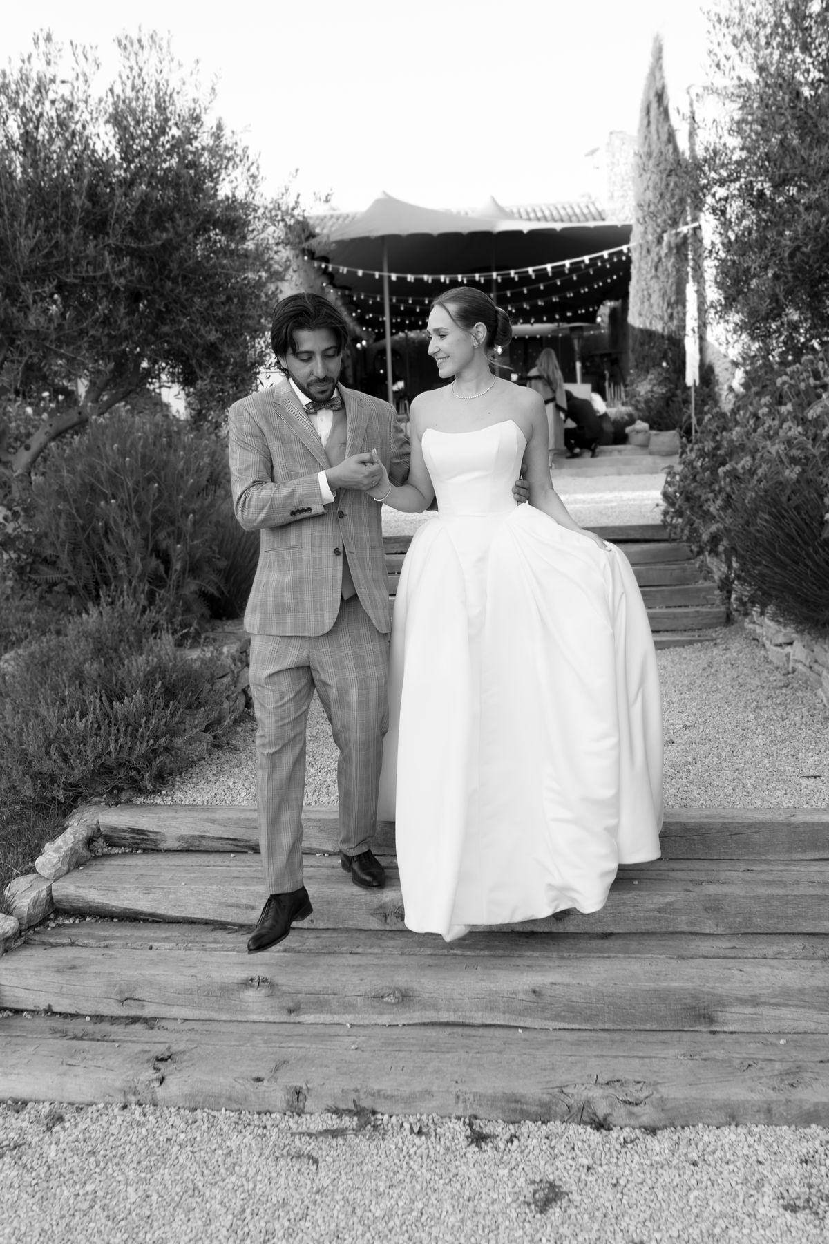 Groom adjusting his jacket before the ceremony, black and white