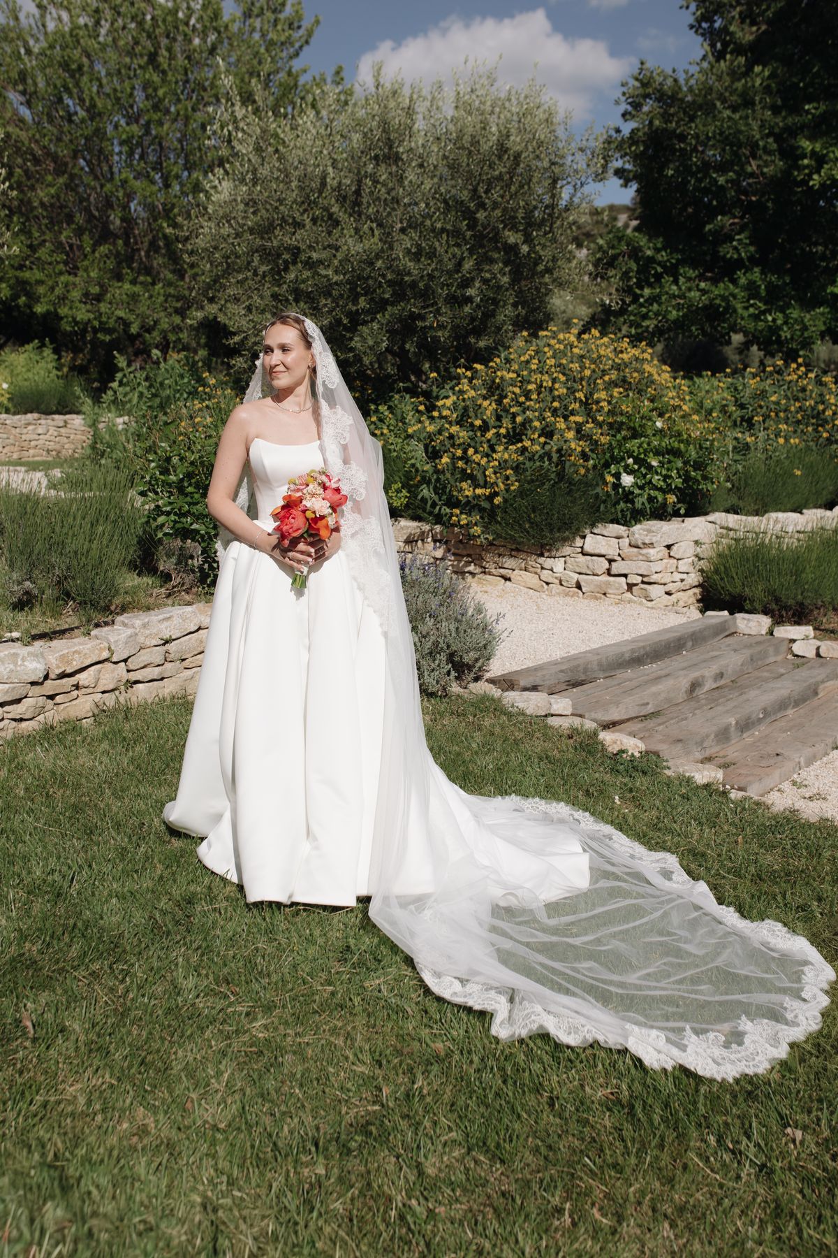 Bride holding her bouquet in the garden at Mas de Florette