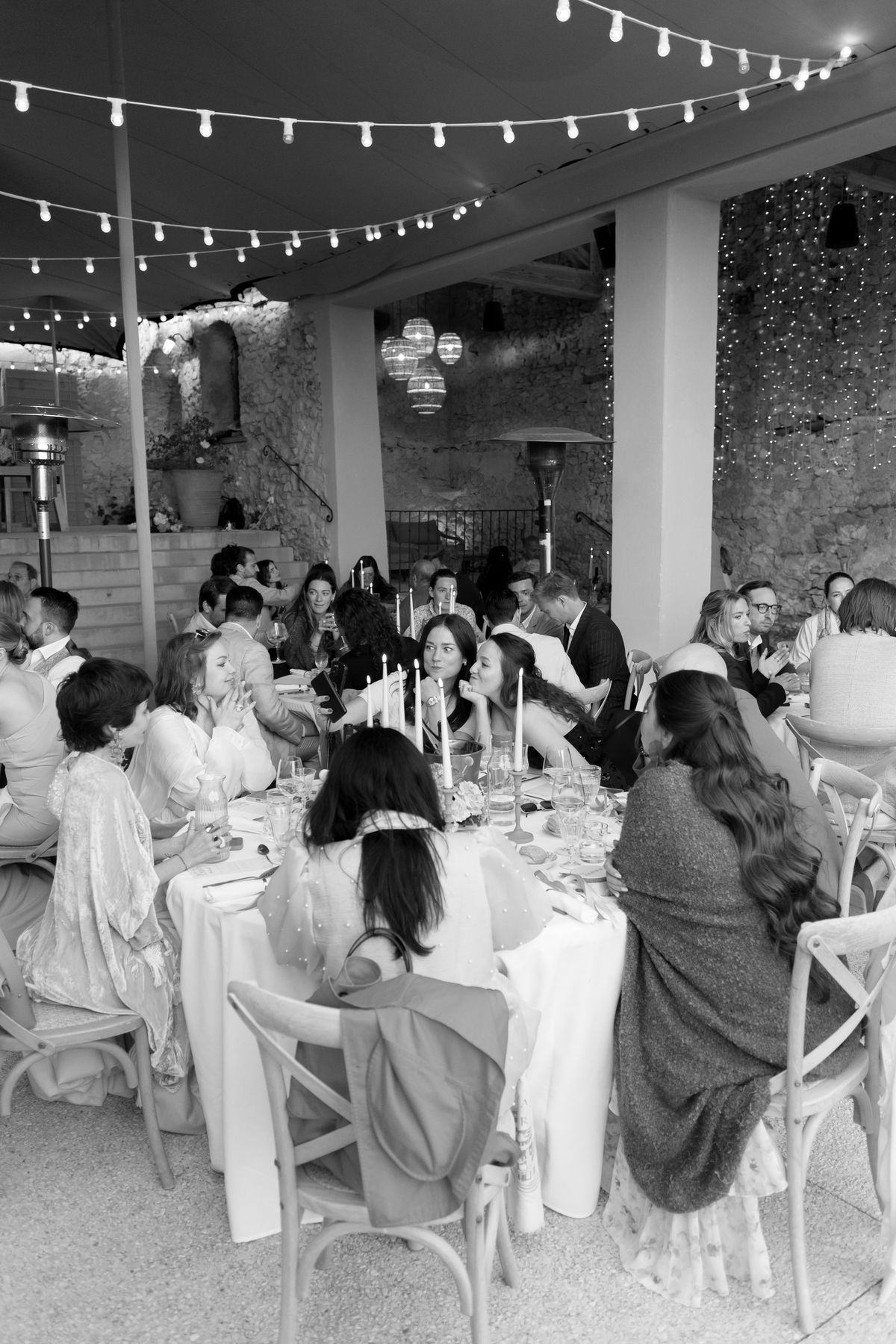 Guests seated at an evening dinner table, black and white