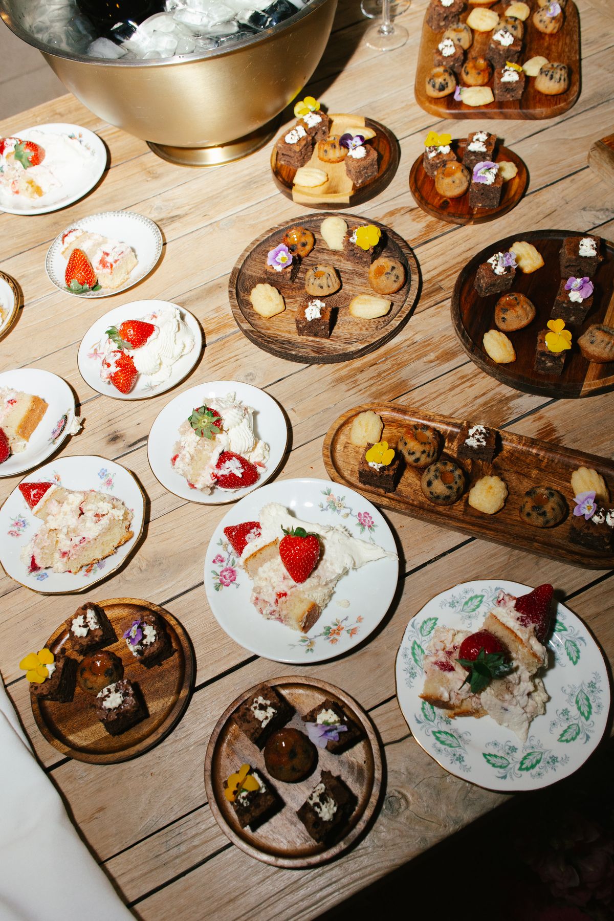 Overhead view of a dessert table with strawberry tarts