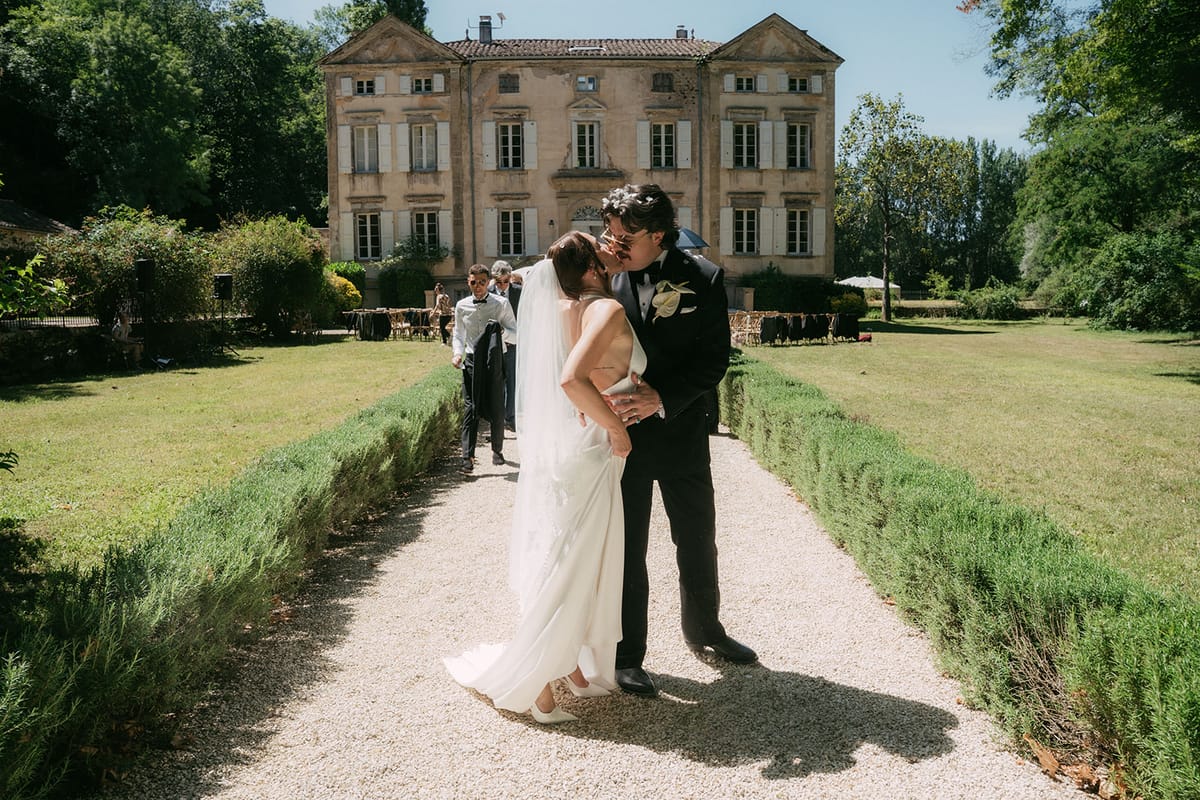 Jasmin and David on the gravel walk, the chateau behind them