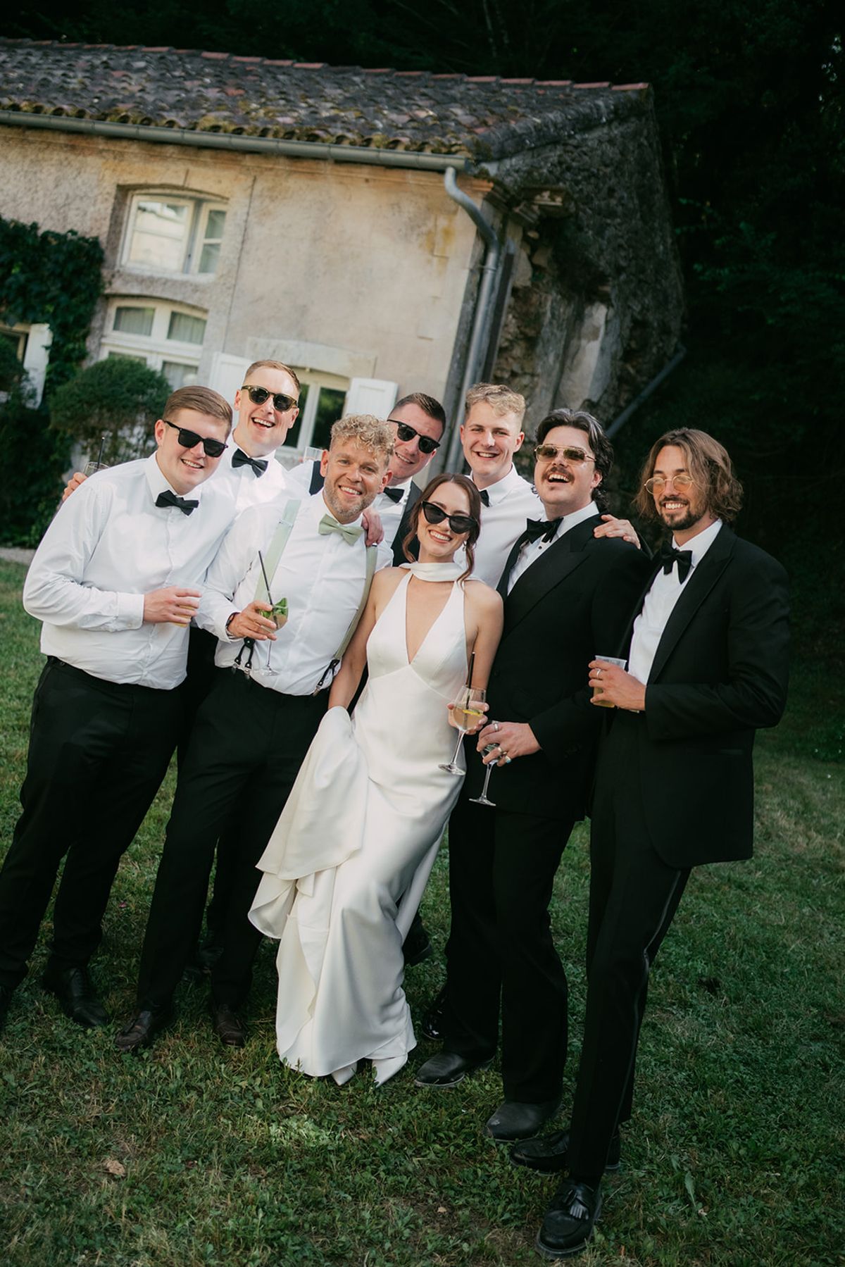 Jasmin and David with the groomsmen, champagne in hand