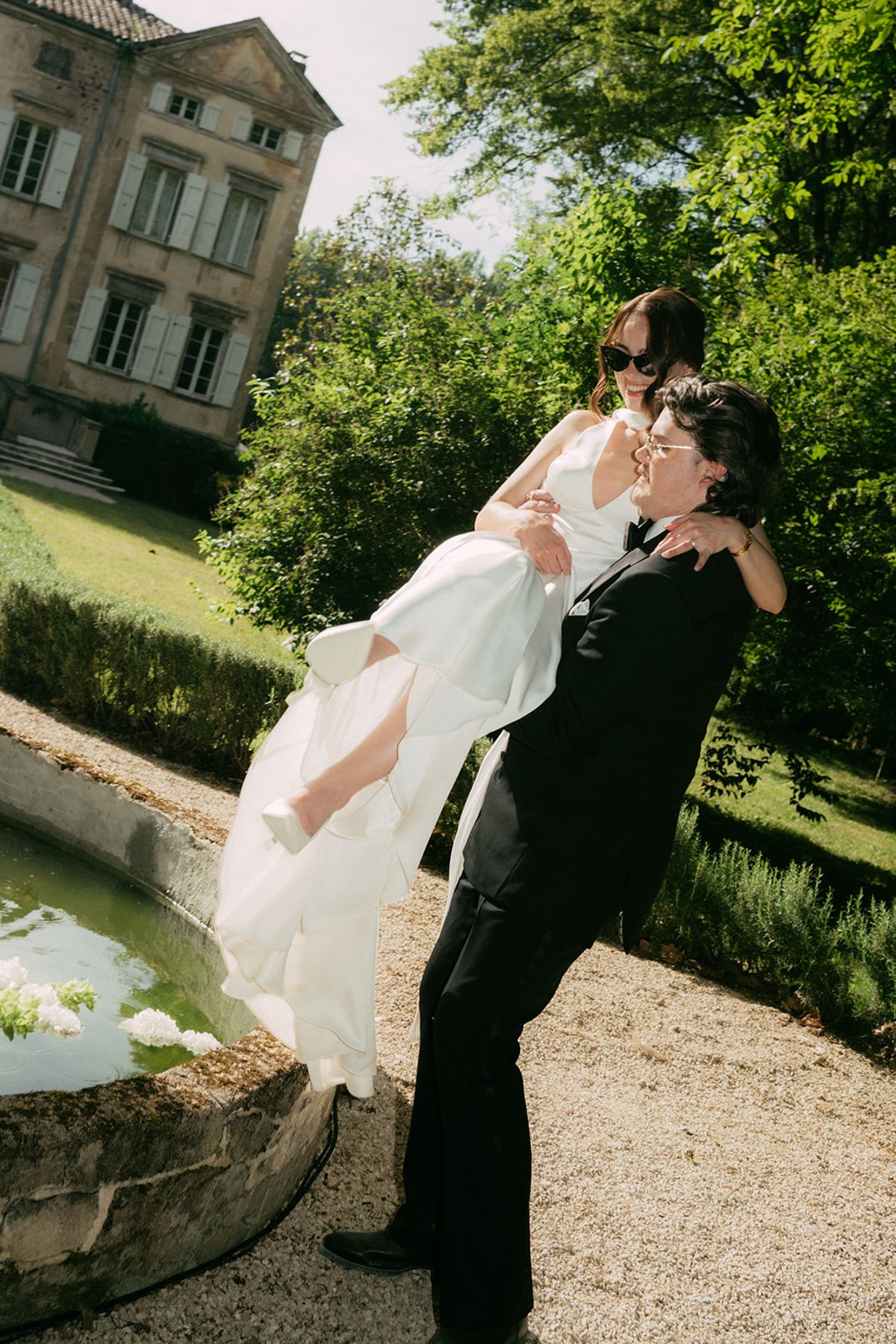 David carrying Jasmin beside the fountain pool