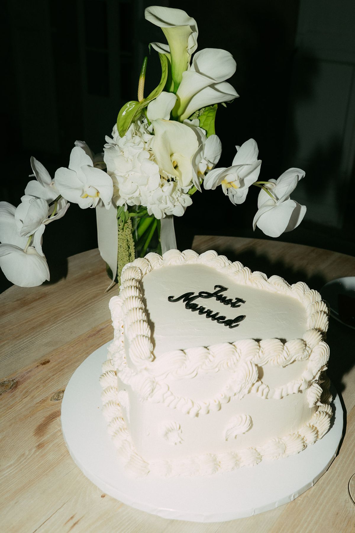 A Just Married cake with white orchids at Chateau du Pont Bourguet
