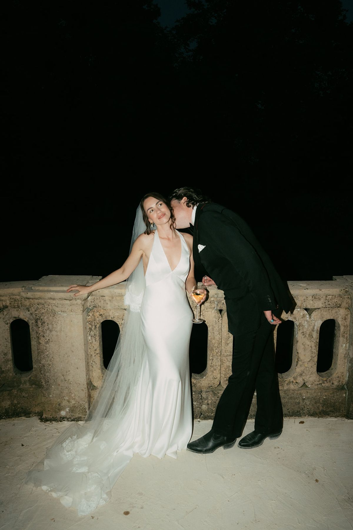 Jasmin and David on the stone balustrade after dark