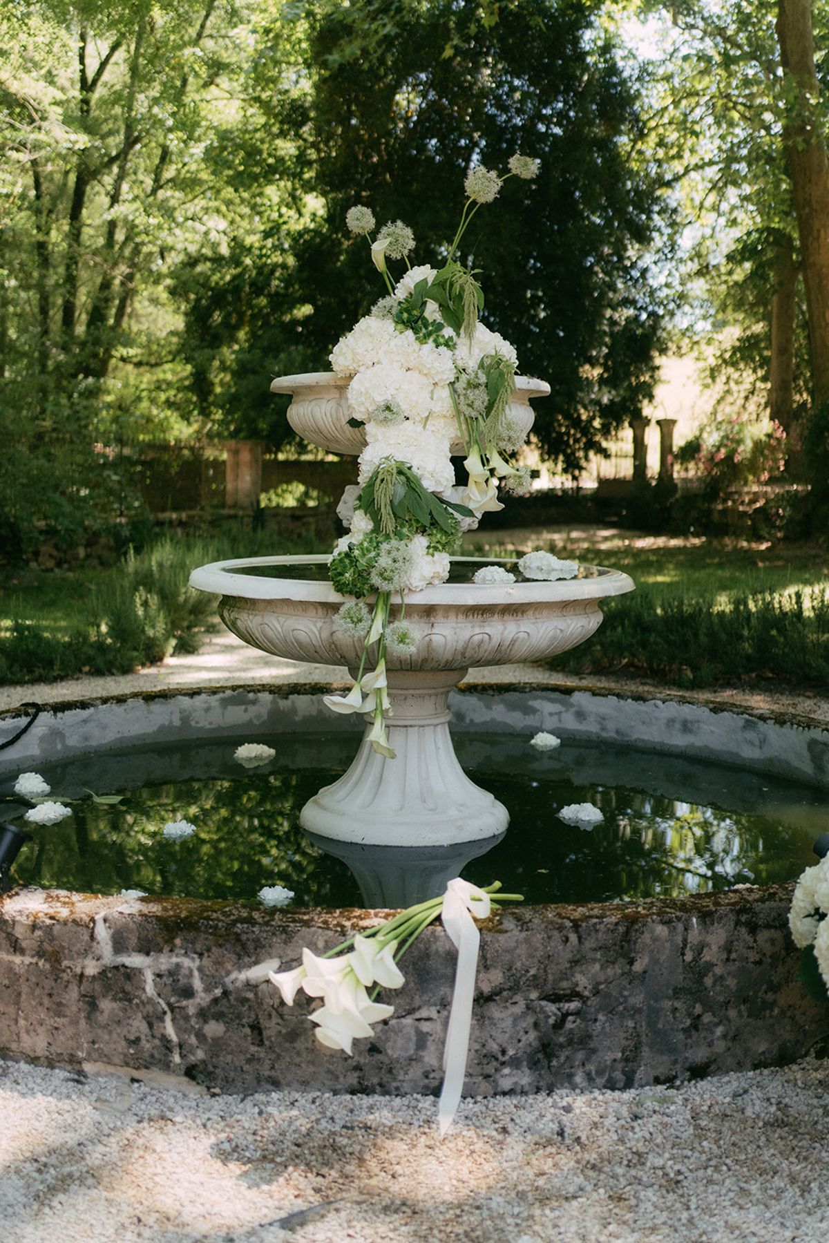 Floral installation cascading from the tiered fountain at Chateau du Pont Bourguet