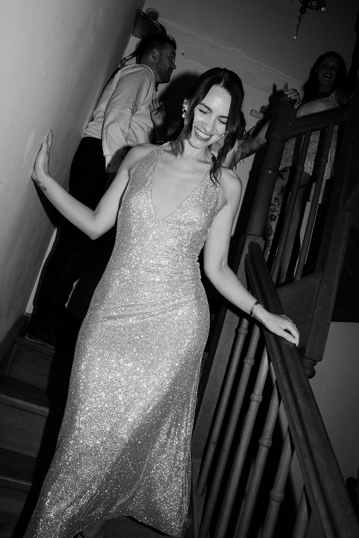 The bride in a sequinned evening dress on the chateau staircase