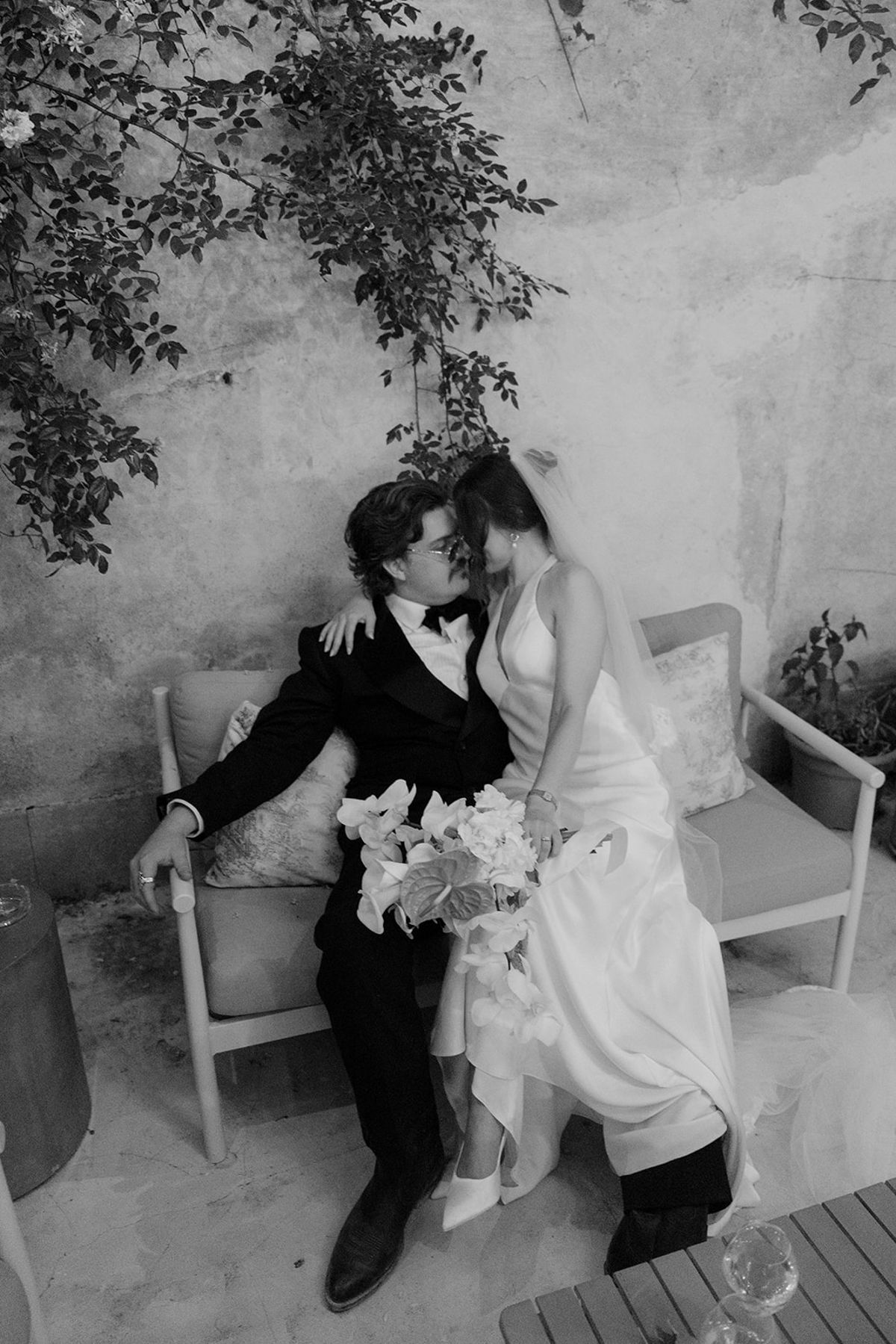 Jasmin and David on a garden bench, photographed in black and white