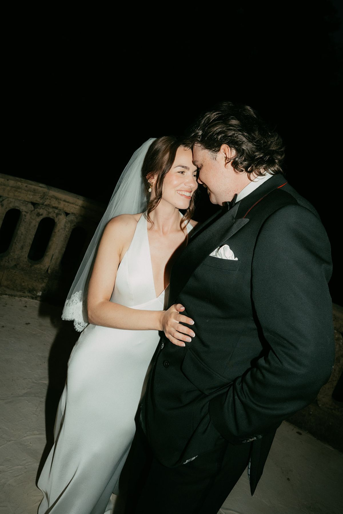 Jasmin and David after dark, her veil lit by flash