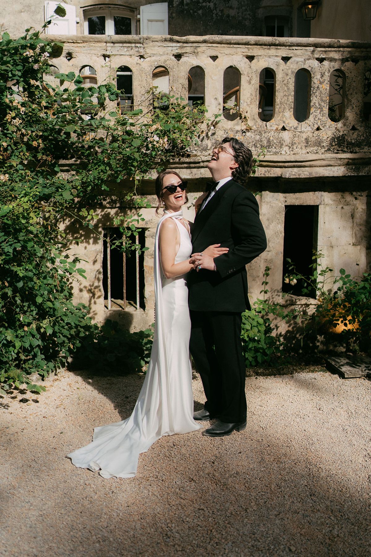 Jasmin and David by the old stone wall at Chateau du Pont Bourguet