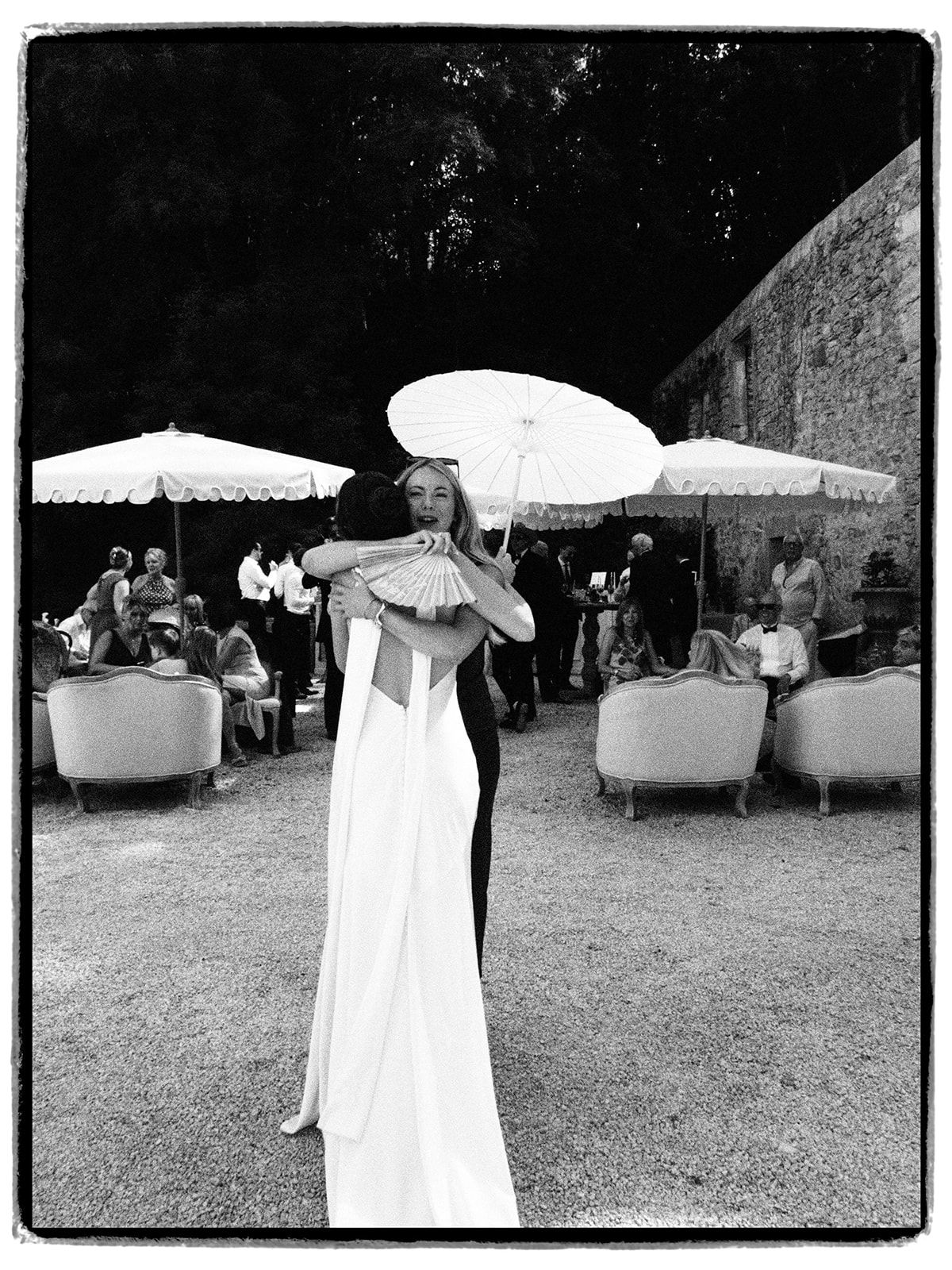 The bride with a parasol during the cocktail hour