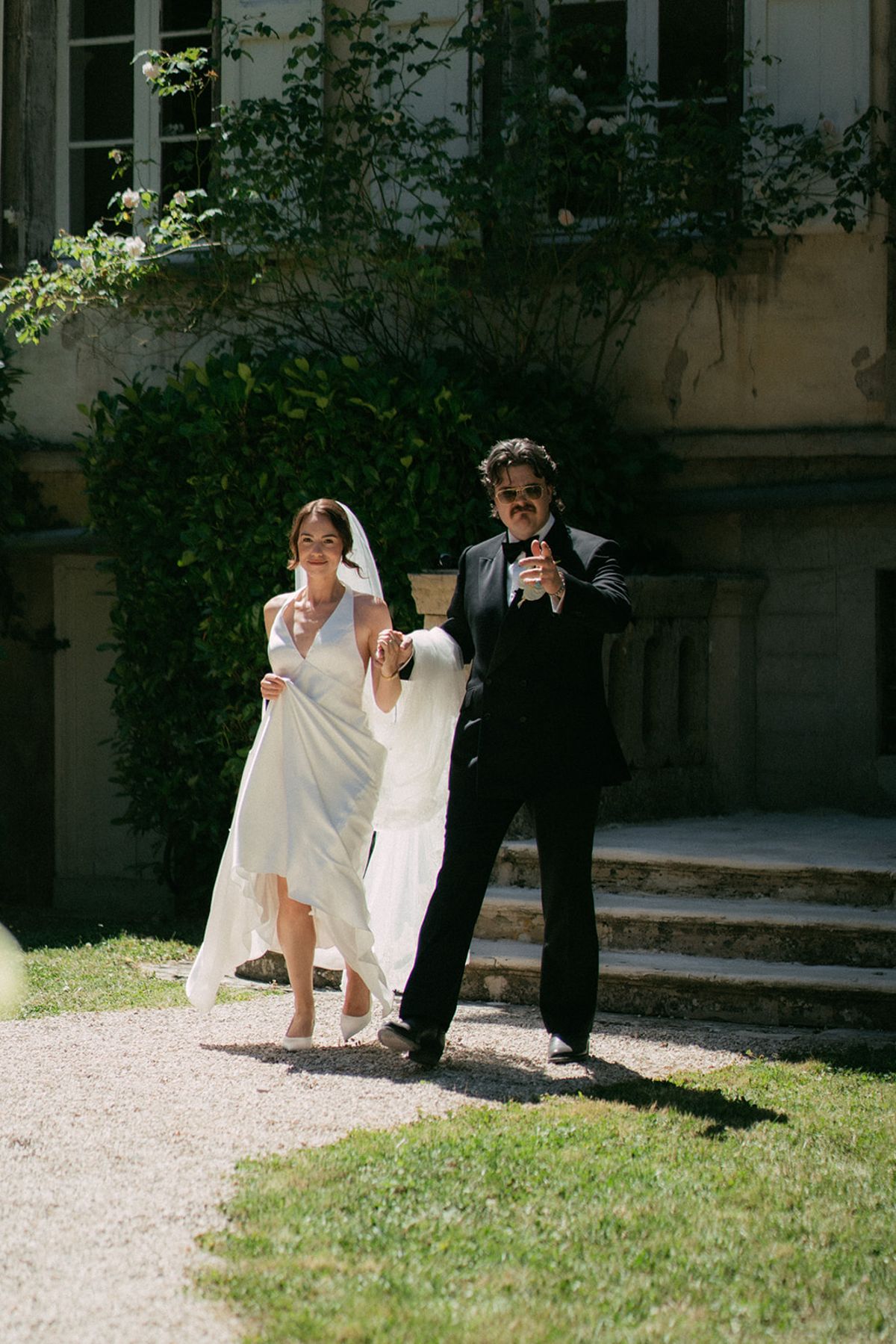 Jasmin and David walking out of the chateau hand in hand