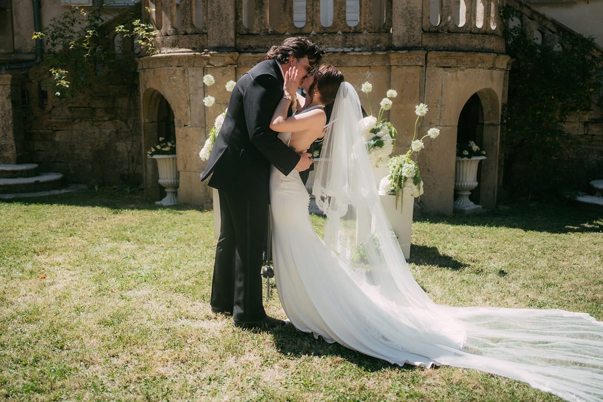 Jasmin and David kissing, her veil catching the light