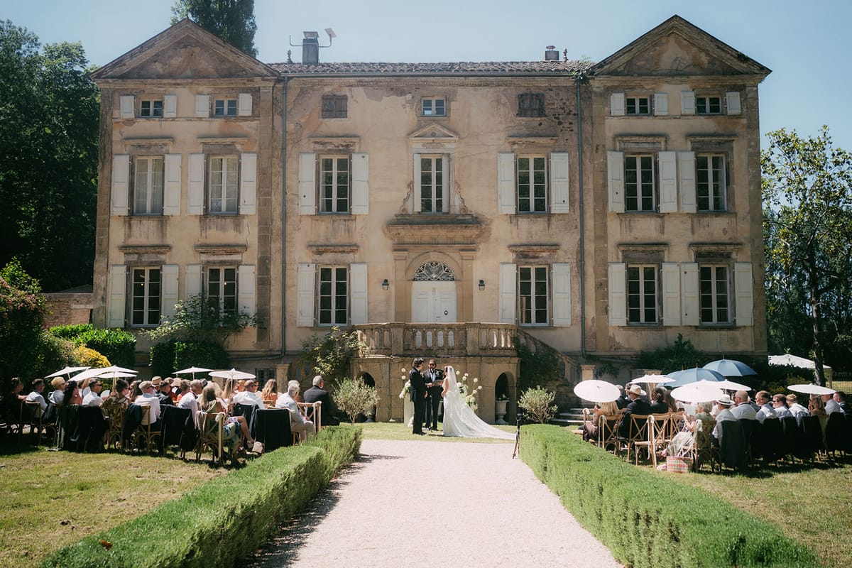 The ceremony in front of the chateau, guests seated on the lawn
