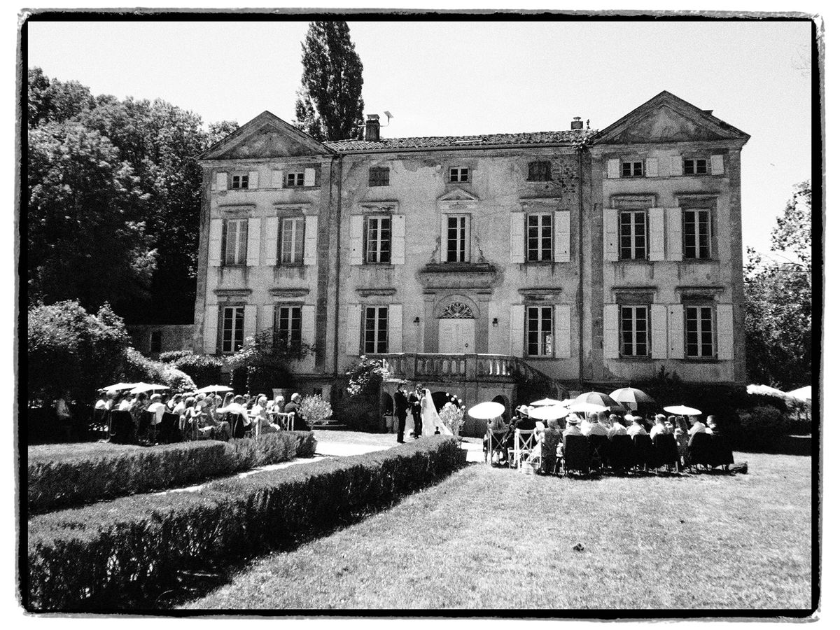 Wide view of the garden ceremony at Chateau du Pont Bourguet, in black and white