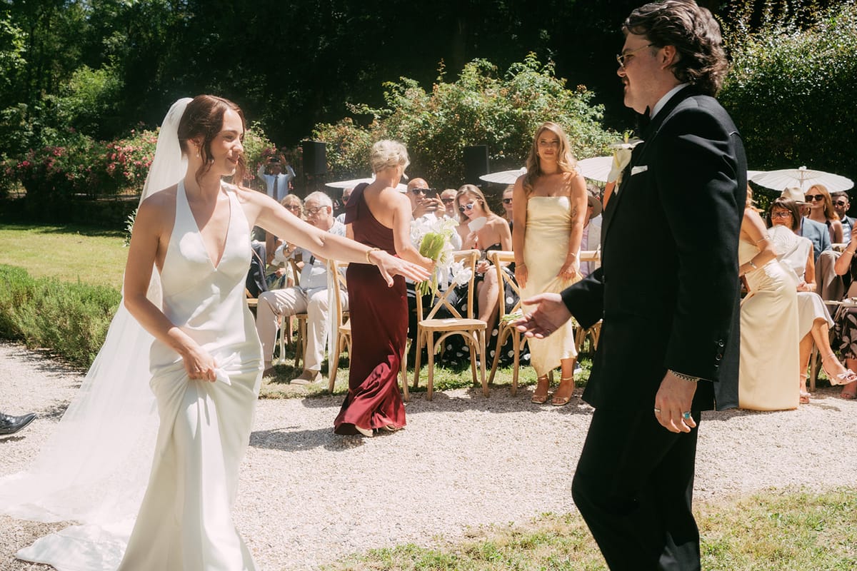 Jasmin and David at the head of the aisle, guests either side