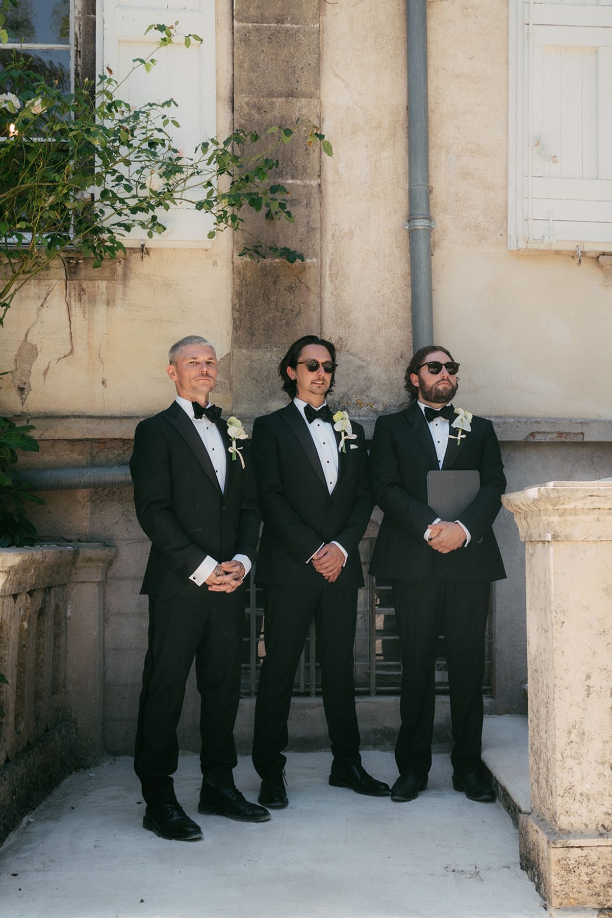 The groom and his groomsmen outside the chateau