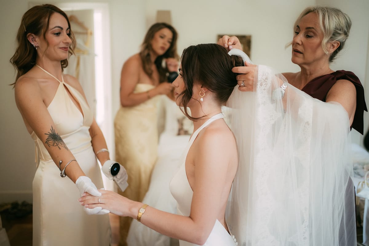The bride's veil being fastened on the morning of the wedding