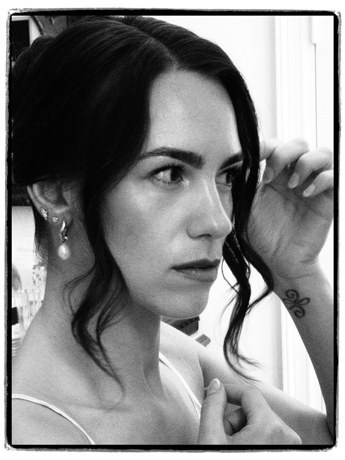 Portrait of the bride by the window before the ceremony
