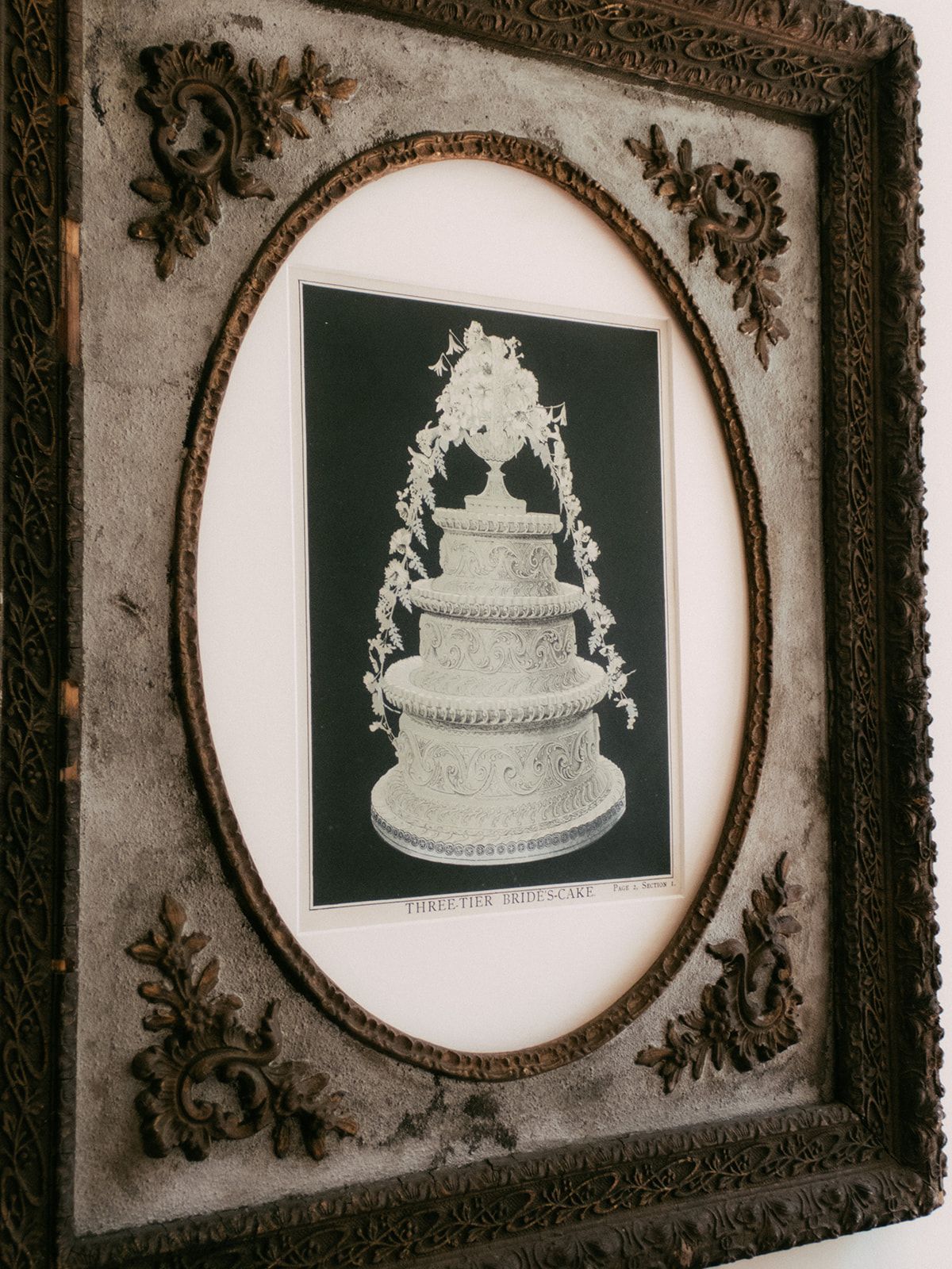 A framed antique engraving of a tiered cake at Chateau du Pont Bourguet