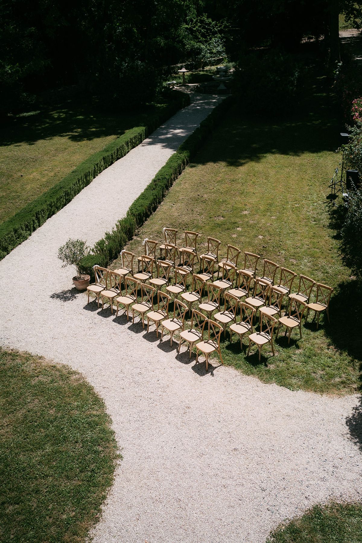 Ceremony chairs set out on the lawn in front of Chateau du Pont Bourguet