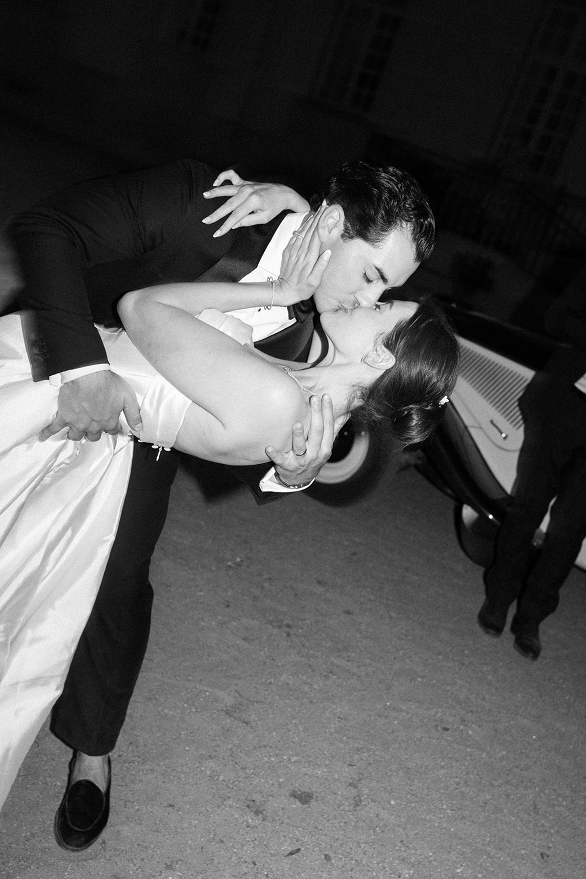 Tyler dipping Haley beside the vintage car at the end of the night