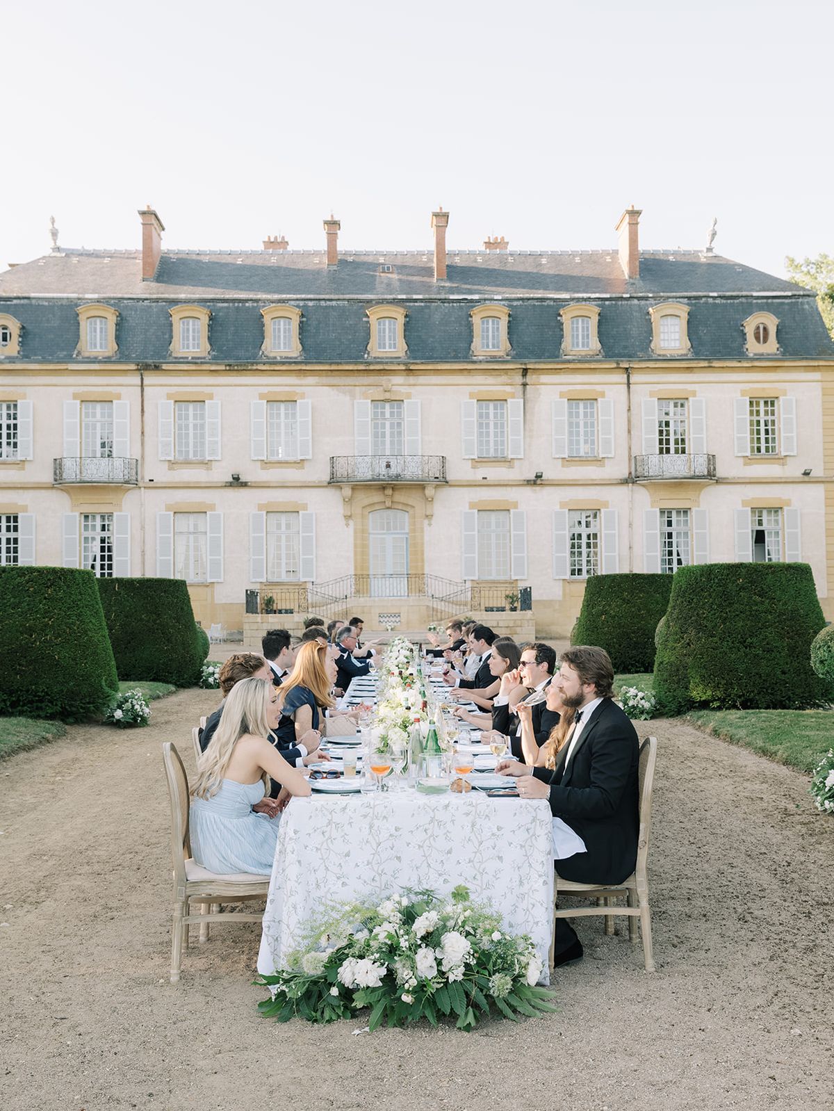 Guests seated at the long table in front of La Chassagne
