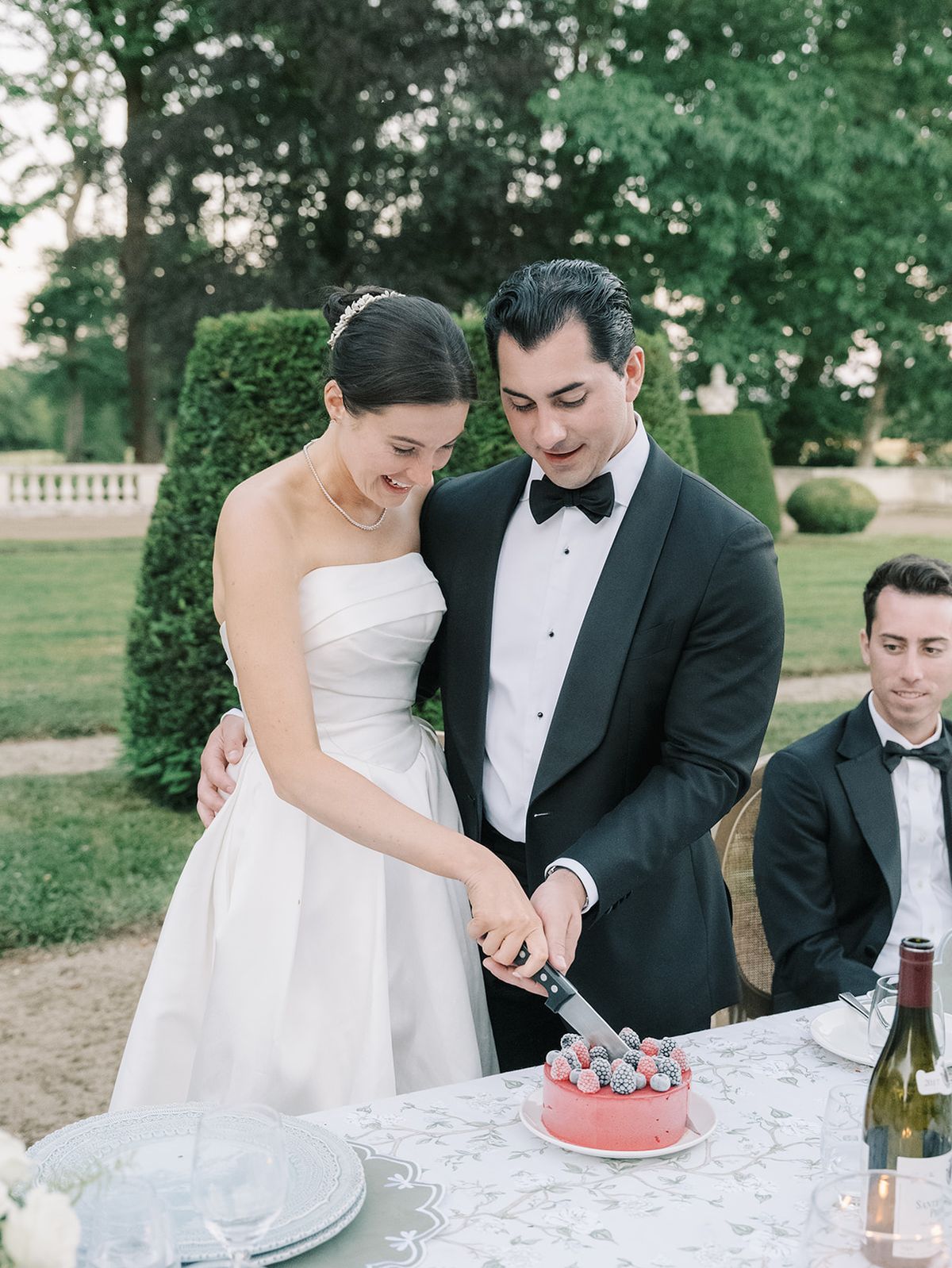 Haley and Tyler cutting the cake at the table