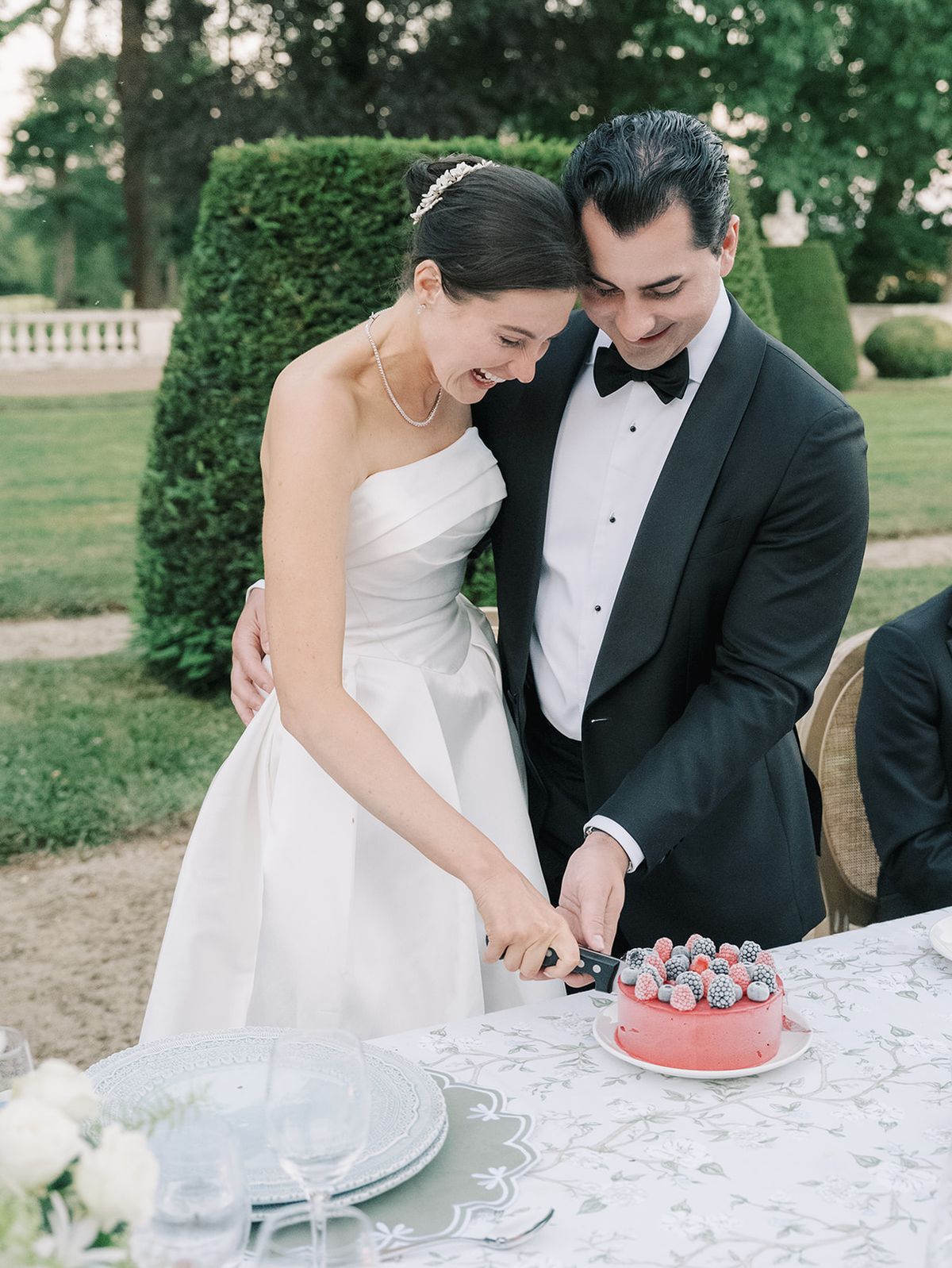 Haley and Tyler cutting into the red glazed cake