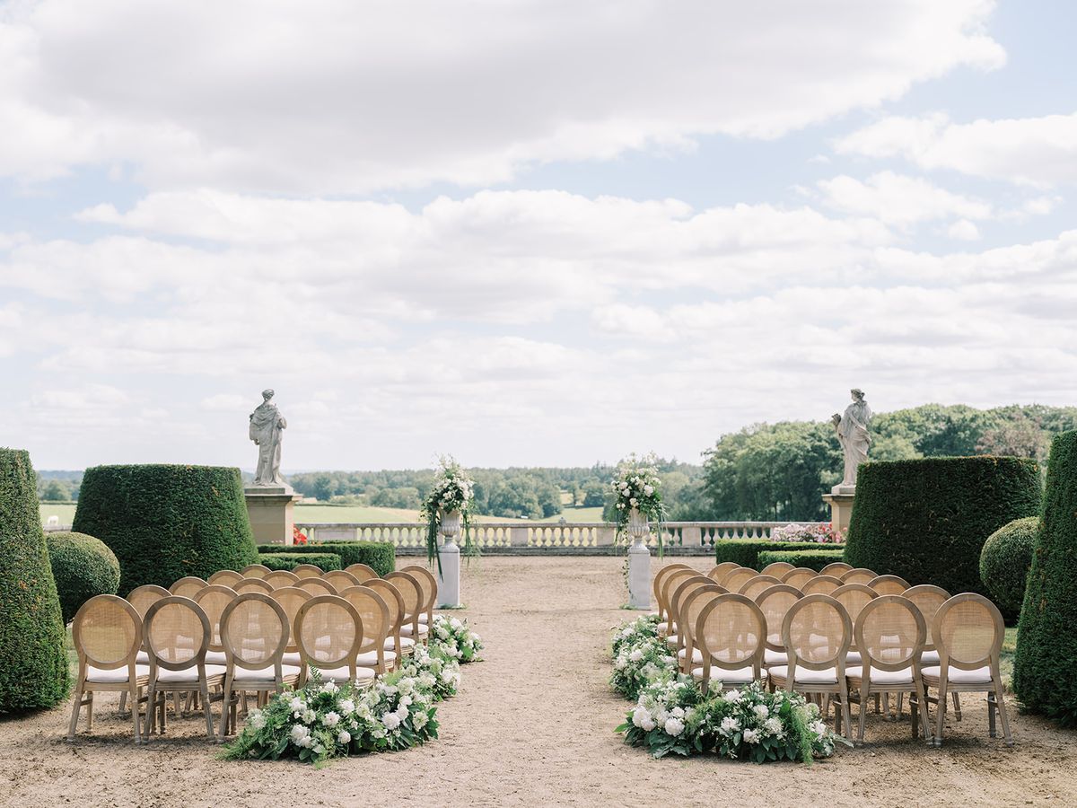 The ceremony chairs and white florals facing the balustrade