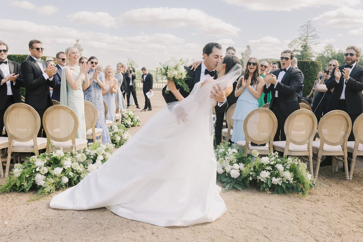 Haley's train trailing behind her as the couple leave the ceremony