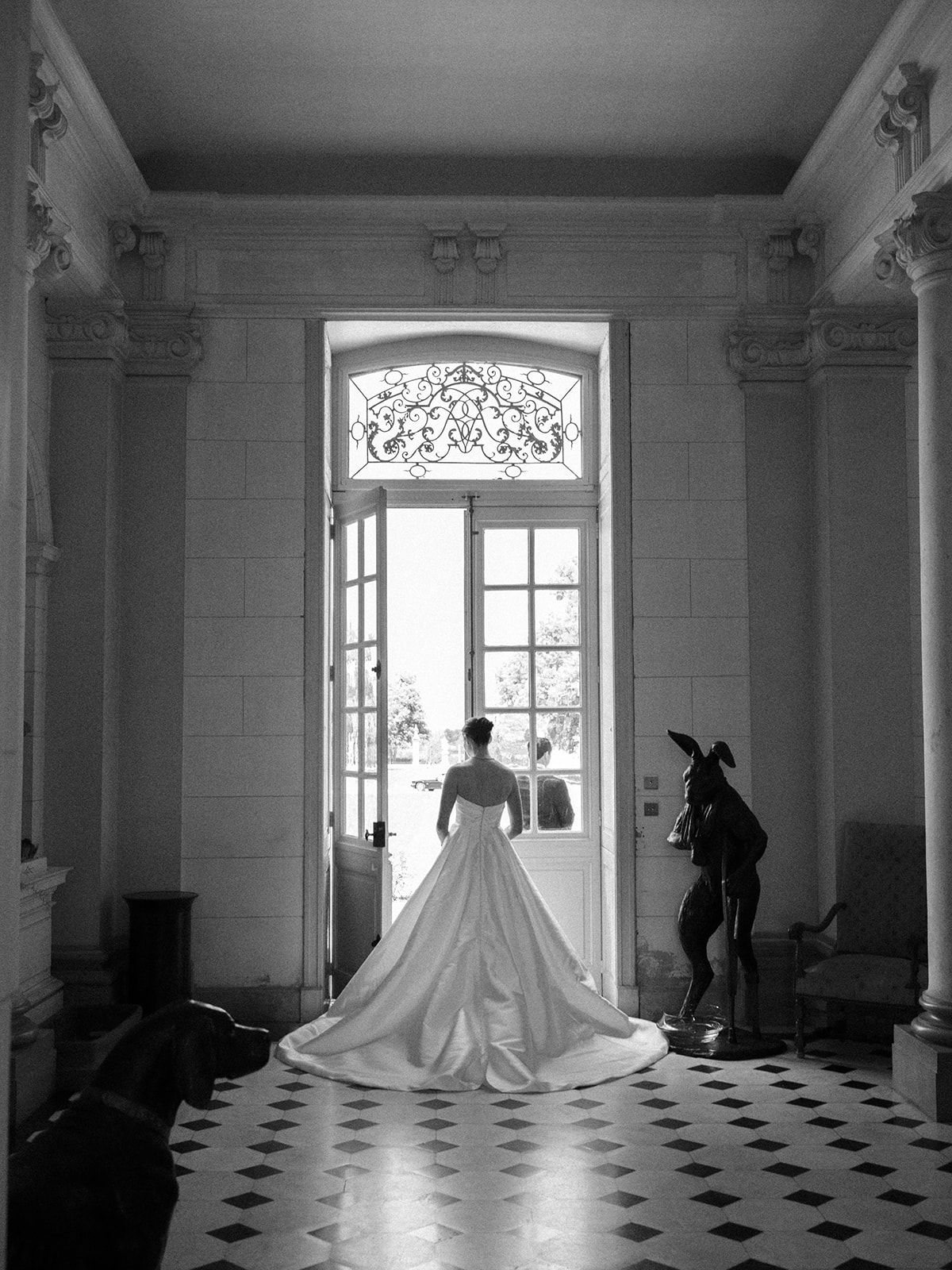 Haley crossing the marble hall toward the open door
