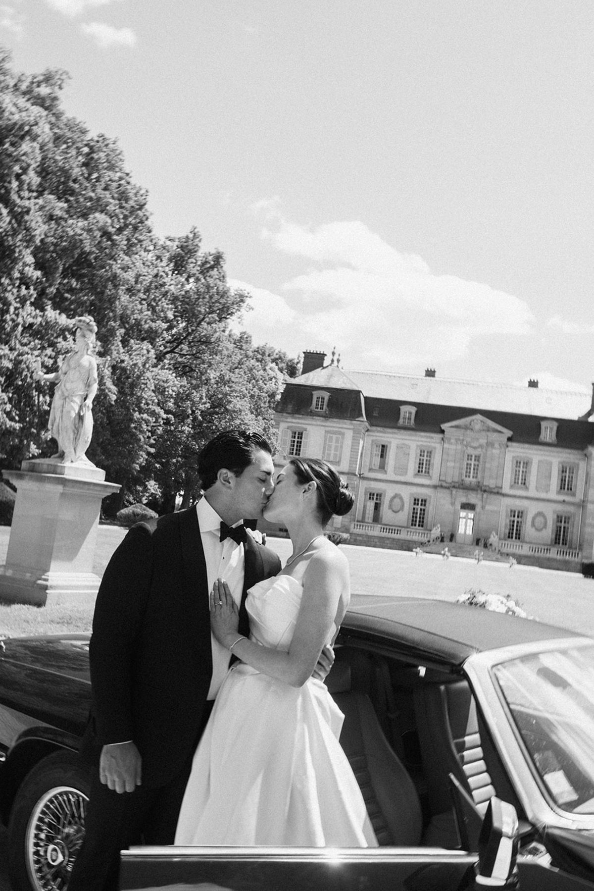 Haley and Tyler beside the vintage car