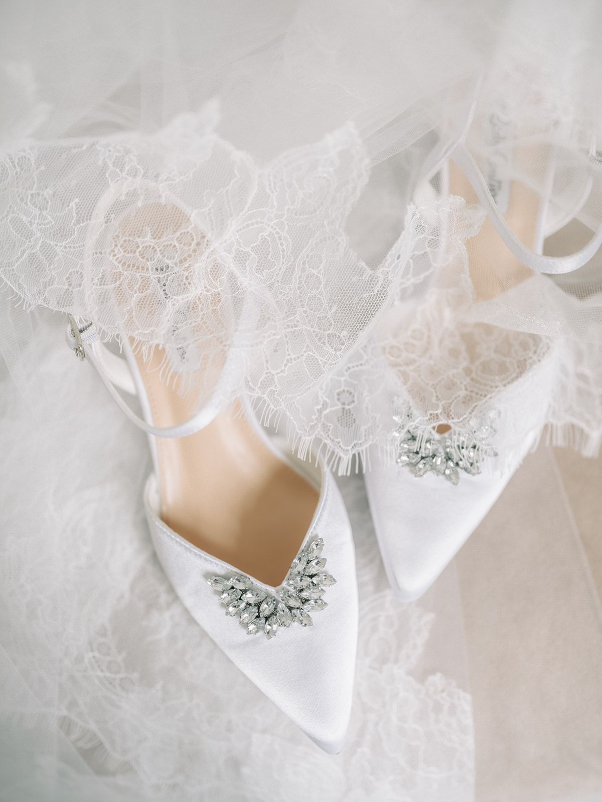 Haley's crystal trimmed shoes resting on her veil