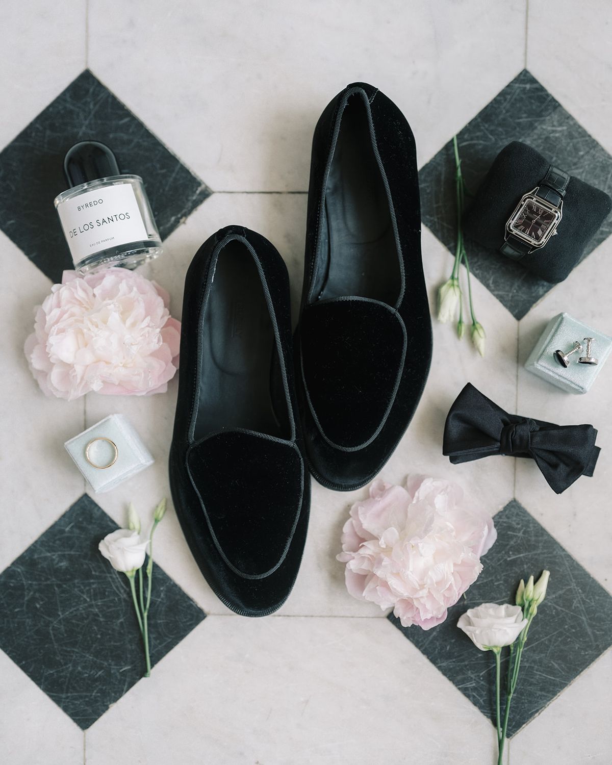 Tyler's shoes, watch, bow tie and cufflinks laid out on marble