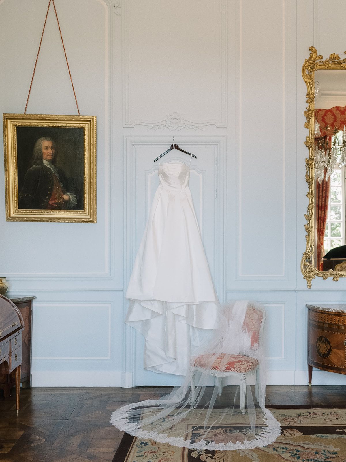 Haley's gown hanging in a panelled room at La Chassagne