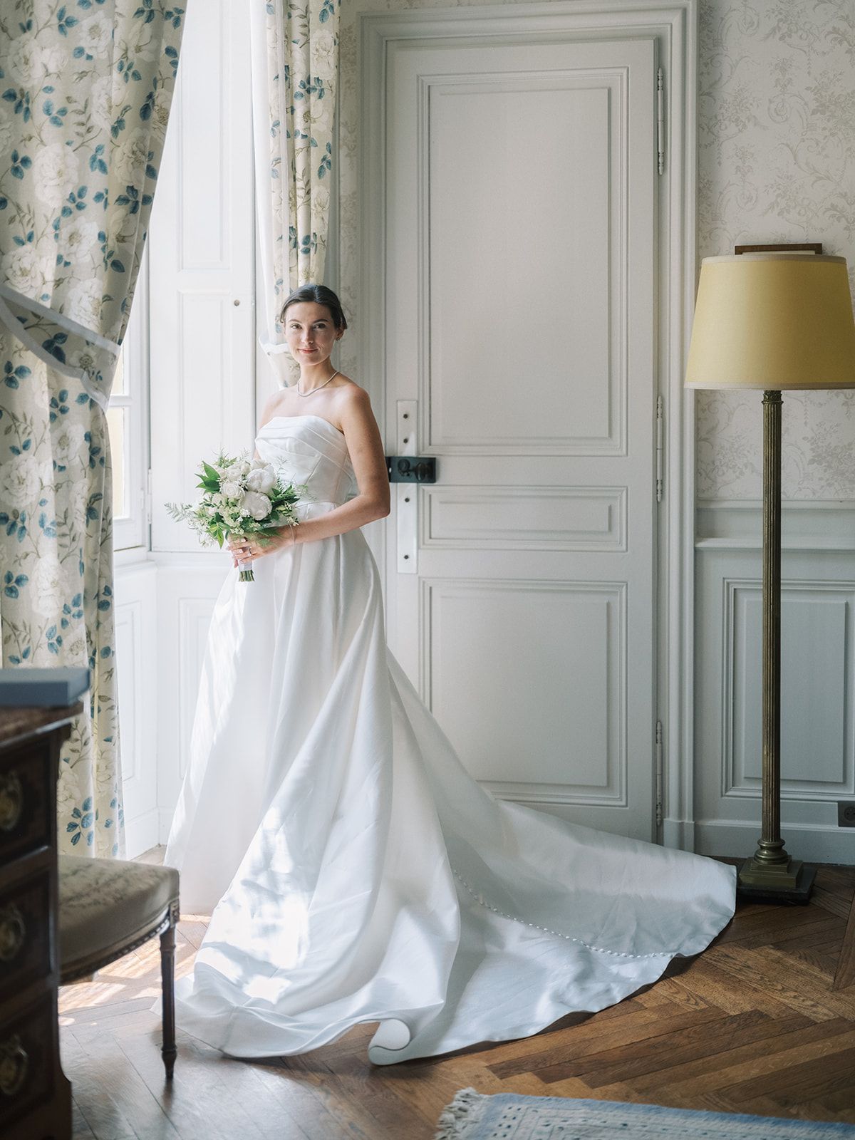 Haley with her bouquet at a window at La Chassagne