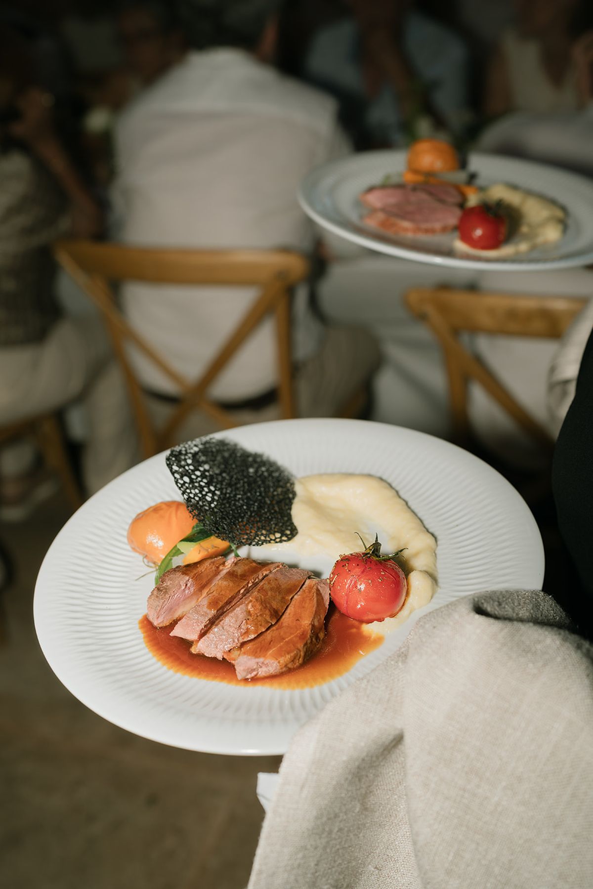 Plates of the main course being served at dinner