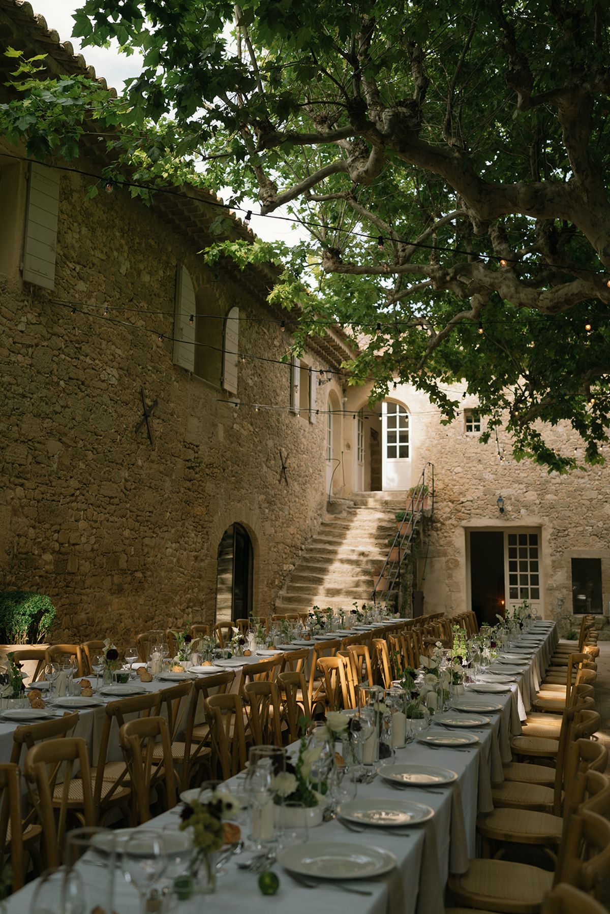 The courtyard at Le Petit Roulet set for dinner beneath the plane trees