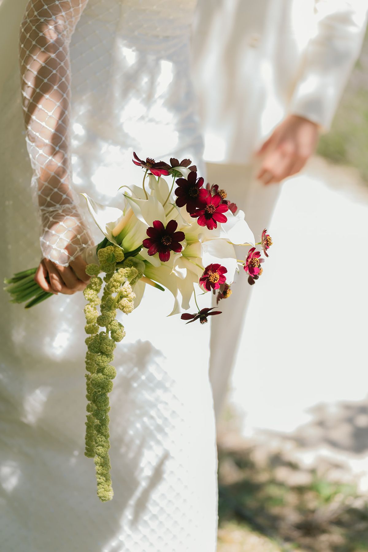 A close view of the bouquet held against the grid-pattern dress