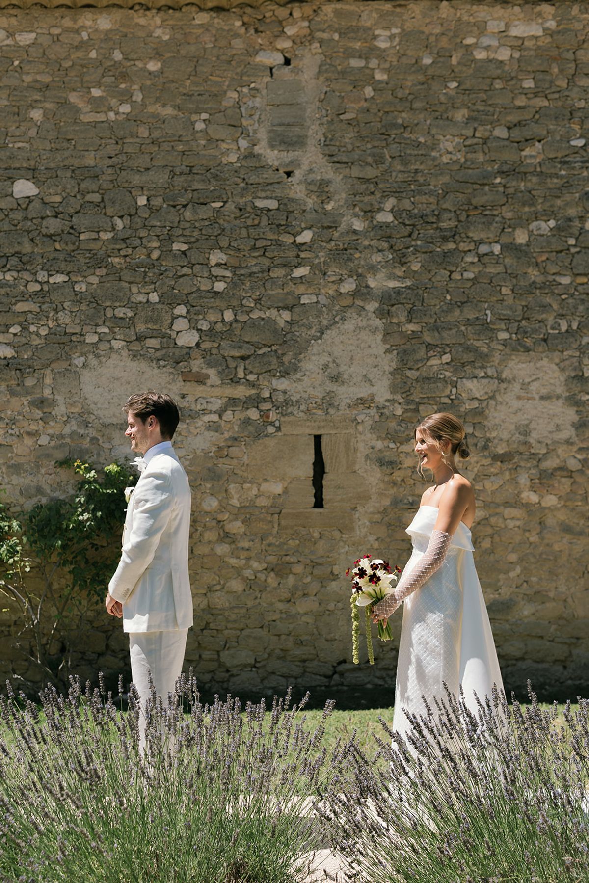 Jolien and Maxime meet for their first look among lavender by an old stone wall at Le Petit Roulet