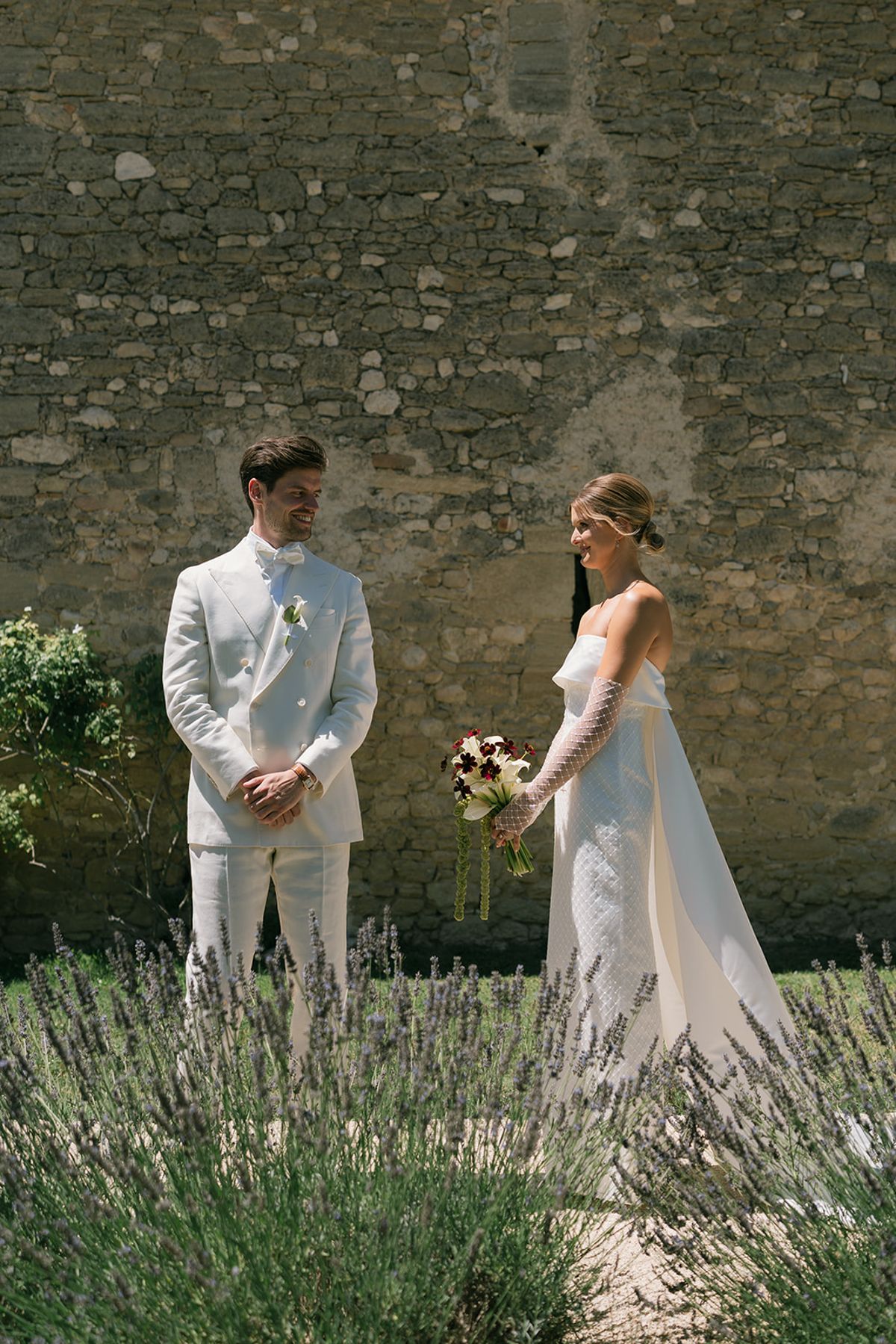 The groom turns to see the bride for the first time beside the lavender