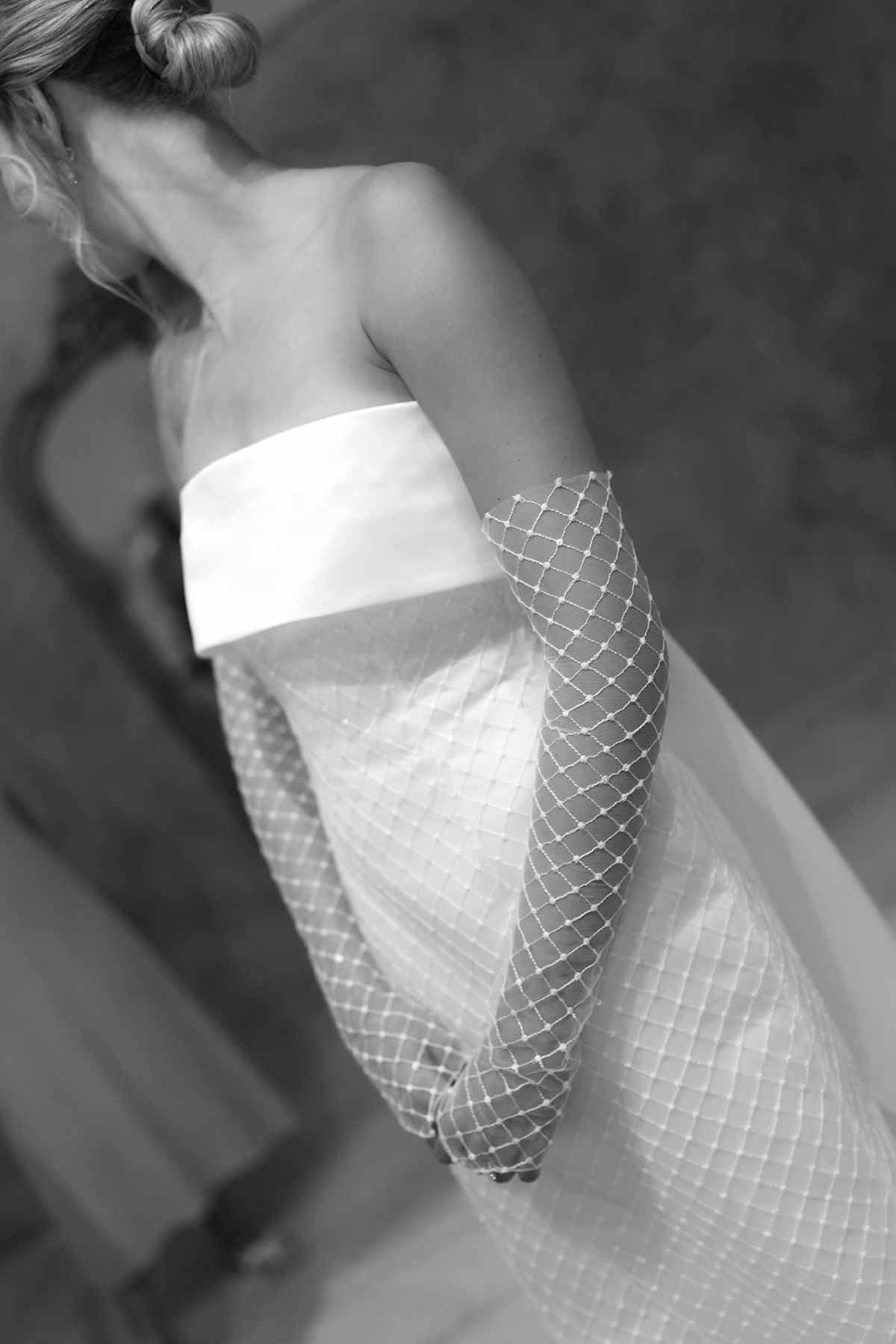 The bride in her strapless bandeau dress with matching lattice-pattern sleeves